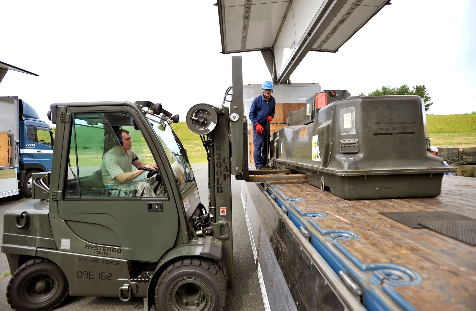 Senior Airman Derek White loads munitions onto a flatbed truck July 13, 2010, at Misawa Air Base, Japan.  Airmen there moved more than 700 tons of munitions in an effort to dispose of unserviceable and unused items.  Airman White is a munitions systems specialist with the 35th Maintenance Squadron.  (U.S. Air Force photo/Staff Sgt. Chad C. Strohmeyer)
