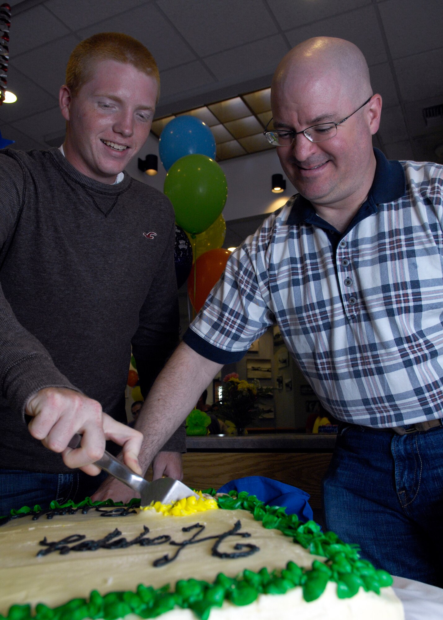 VANDENBERG AIR FORCE BASE, Calif. – By age, the youngest, Airman Jonathon Parr, of the 532nd Training Squadron, and the oldest, Master Sgt. John Shade, the 30th Space Launch Squadron first sergeant, cut the cake at a birthday celebration at Breakers Dining Facility here Wednesday, July 14, 2010. The birthday celebration was for those individuals who celebrated their birthdays between April and June. (U.S. Air Force photo/Airman 1st Class Lael Huss) 