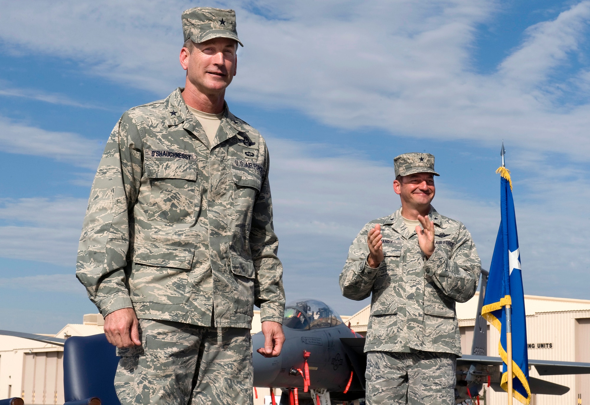 NELLIS AIR FORCE BASE, Nev.-- Brig. Gen. Terrence O'Shaughnessy, the new 57th Wing commander, stands with Brig. Gen. Russell J. Handy, the former wing commander, at the change of command ceremony July 16. The 57th Wing is responsible for 38 squadrons at 12 installations, constituting the Air Force's most diverse flying wing, flying and maintaining more than 130 aircraft. The 57th Wing also oversees the U.S. Air Force Weapons School; U.S. Air Force Air Demonstration Squadron, the Thunderbirds; and the Red Flag and Green Flag exercises. (U.S. Air Force Photo by Airman 1st Class Brett Clashman)