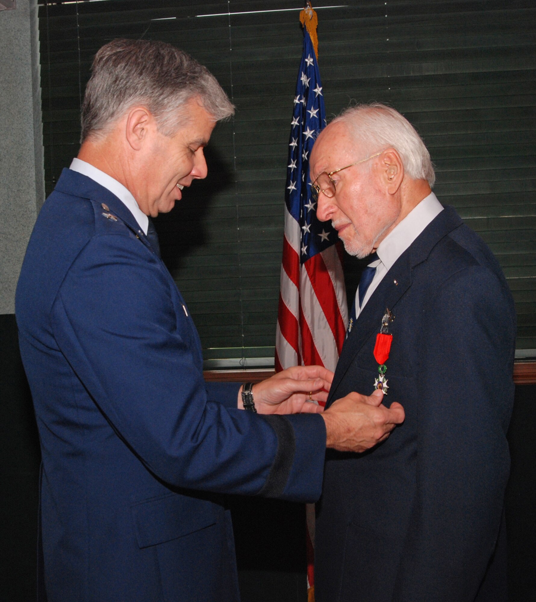 Brig. Gen. Walter Givhan presents retired Air Force Col. Byron Lee Schatzley with the Knight of the Legion of Honor medal July 13 at Wright-Patterson Air Force Base, Ohio. Colonel Schatzley was recognized for his service as bombardier in the 558th Bomb Squadron during World War II.  Napolean Bonaparte created the medal to honor military and non-military people for outstanding bravery or achievement in service to France.  General Givhan is Air Force Institute of Technology Commandant and presented the medal on behalf of the Consulate General of France in Chicago. (U.S. Air Force photo/Bonnie White)