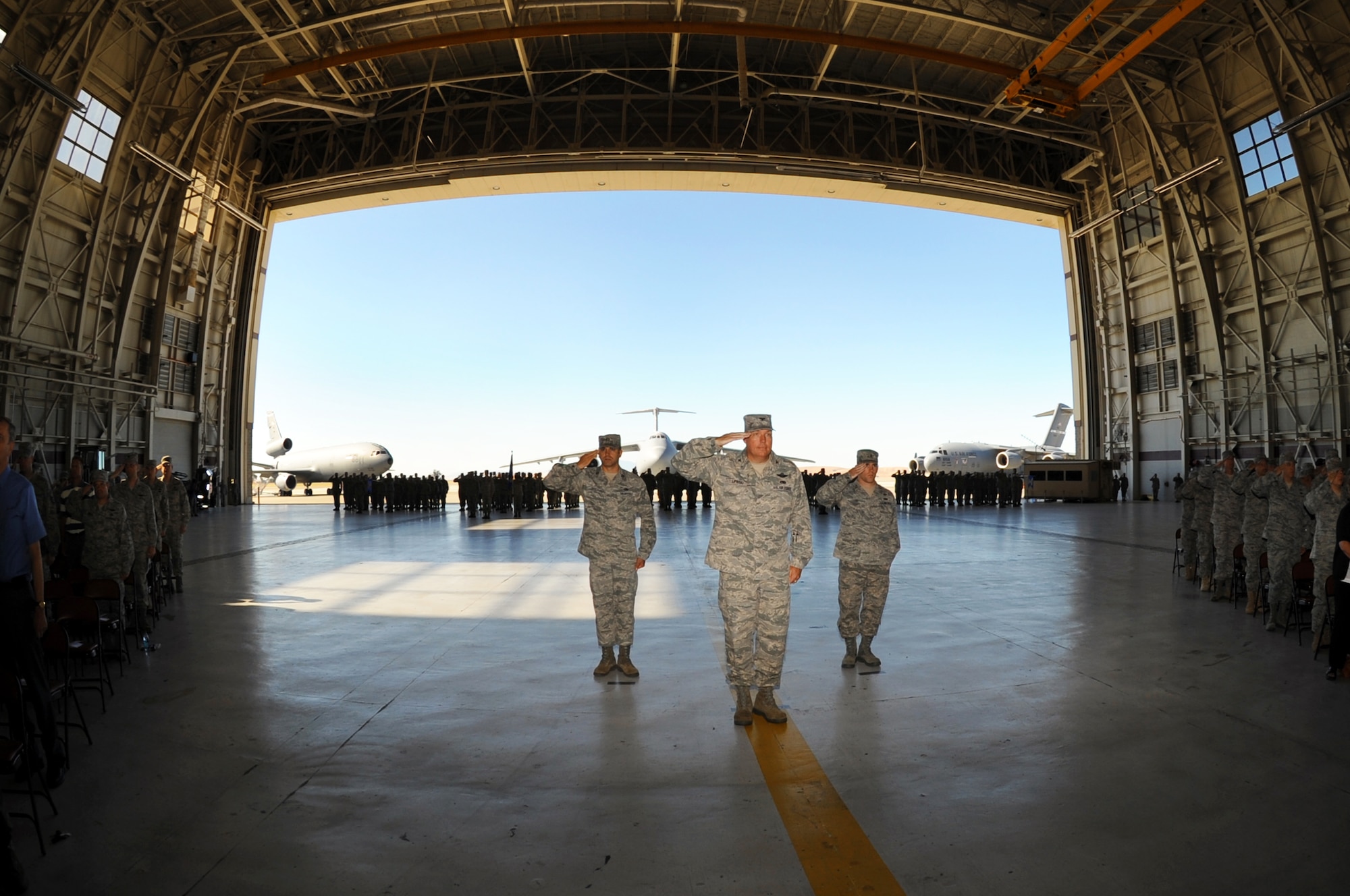 Left to right, 1st Lt. Bridger Lord, 573rd Global Support Squadron, Col. John Lipinski, commander of the 615th Contingency Response Wing, and Capt. Thomas Freeland, 15th Air Mobility Squadron salute the newest 15th EMTF commander, Col. Robert D. Thomas for the first time during 15th EMTF change of command ceremony.  (U.S. Air Force photo by Civ/Nan Wylie)