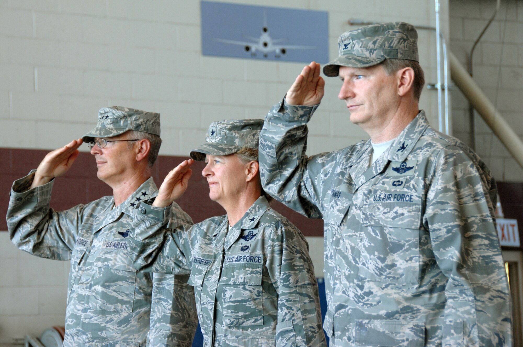 Left to right, Lt. Gen.Robert R. Allardice, 18th Air Force commander, Brig. Gen. Barbara J. Faulkenberry, outgoing 15th Expeditionary Mobility Task Force commander and Col. Robert D. Thomas, incoming 15th EMTF commander, render honors to the flag during the national anthem prior to the 15th EMTF change of command ceremony  July 15th.  (U.S. Air Force photo by Civ/Nan Wylie)
