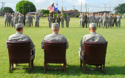 SOTO CANO AIR BASE, Honduras --  As the Army Forces change of command ceremony is about to begin, Lt. Col. Craig Gendreau, left, Col. Gregory Reilly and Lt. Col. Curtis Anderson II watch over the Army Forces and Headquarters and Support Company elements here July 16. Colonel Reilly, the Joint Task Force-Bravo commander, presided over the ceremony as Colonel Gendreau took command of ARFOR from Colonel Anderson. (U.S. Air Force photo/Martin Chahin)