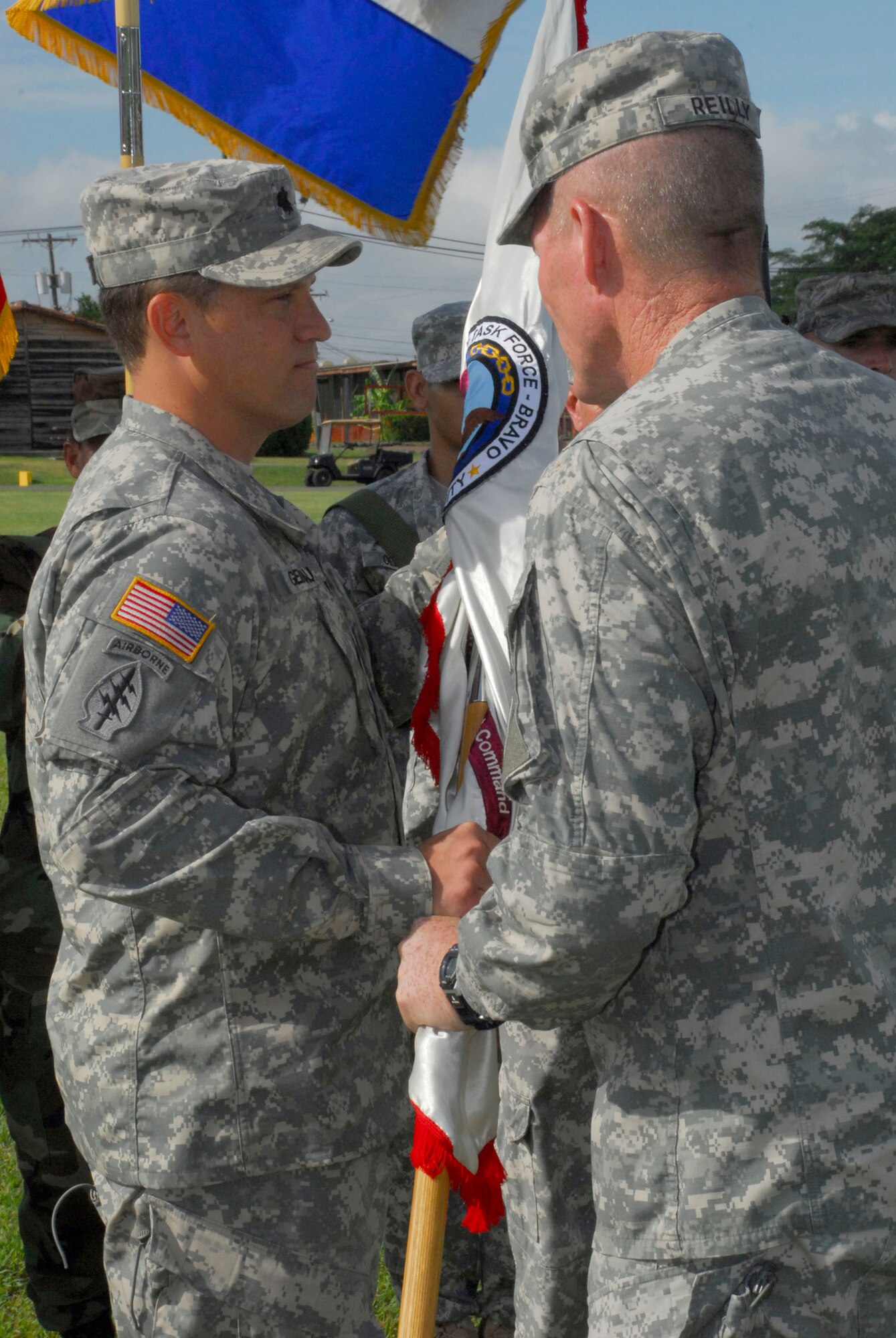SOTO CANO AIR BASE, Honduras --  Col. Gregory Reilly, right, the Joint Task Force-Bravo commander, hands the Army Forces guidon to Lt. Col. Craig Gendreau during the ARFOR change of command ceremony here July 16. Colonel Gendreau took command of ARFOR from Lt. Col. Curtis Anderson II. (U.S. Air Force photo/Martin Chahin)