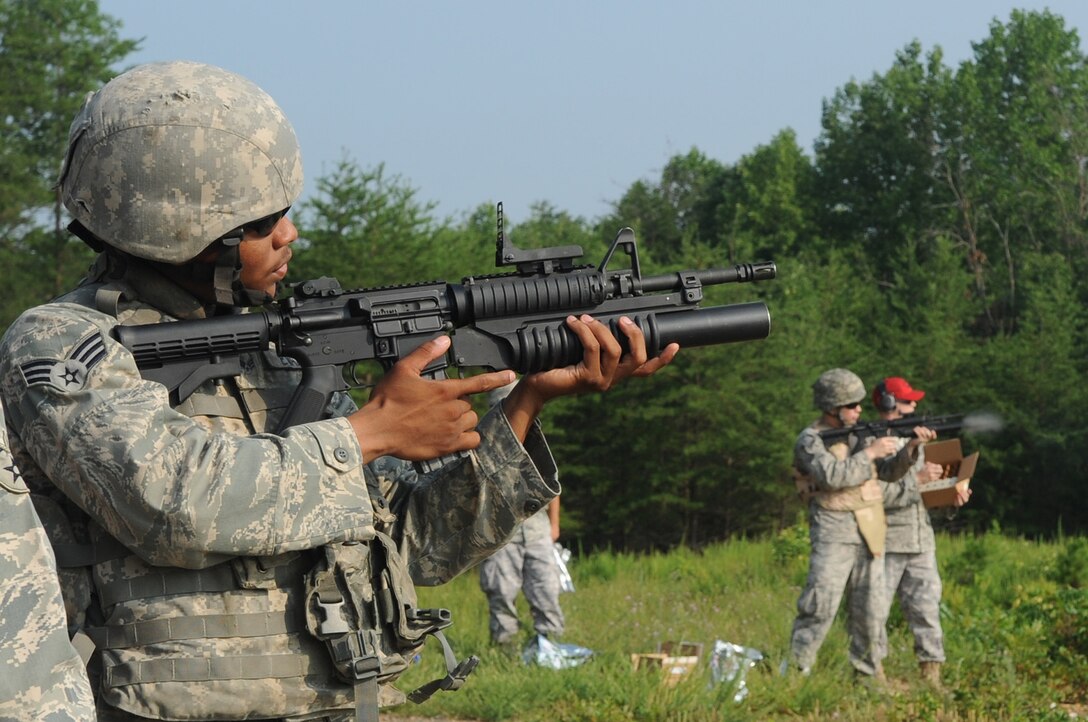 Senior Airman Bennie Evans, 316th Security Forces Squadron patrolman, prepares to fires a M203 grenade launcher at Marine Corps Base Quantico, July 15, 2010. 316th SFS combat arms instructors qualify base defenders and forward deploying members as needed on the M203 using practice rounds that that fire up to 400 meters. (U.S. Air Force photo by Senior Airman Melissa V. Brownstein)