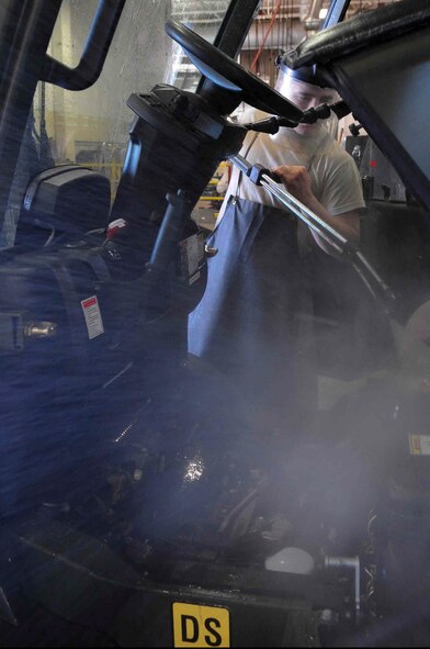ELLSWORTH AIR FORCE BASE, S.D. – Airman 1st Class Rodney Lewis, 28th Logistics Readiness vehicle and vehicular equipment maintenance journeyman, washes a forklift, July 16.  The vehicle maintenance shop operates, cleans, services and performs preventative maintenance on government vehicles. (U.S. Air Force Photo/Airman 1st Class Corey Hook)