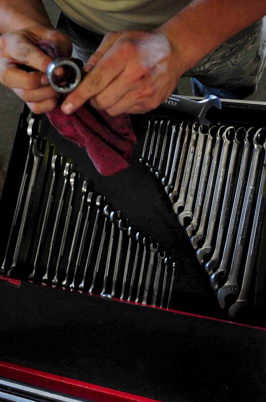 ELLSWORTH AIR FORCE BASE, S.D. – Airman 1st Class Rodney Lewis, 28th Logistics Readiness vehicle and vehicular equipment maintenance journeyman, wipes down a wrench after use, July 16.  The vehicle maintenance shop is responsible for the maintenance of  Ellsworth’s 673 government vehicles. (U.S. Air Force Photo/Airman 1st Class Corey Hook)