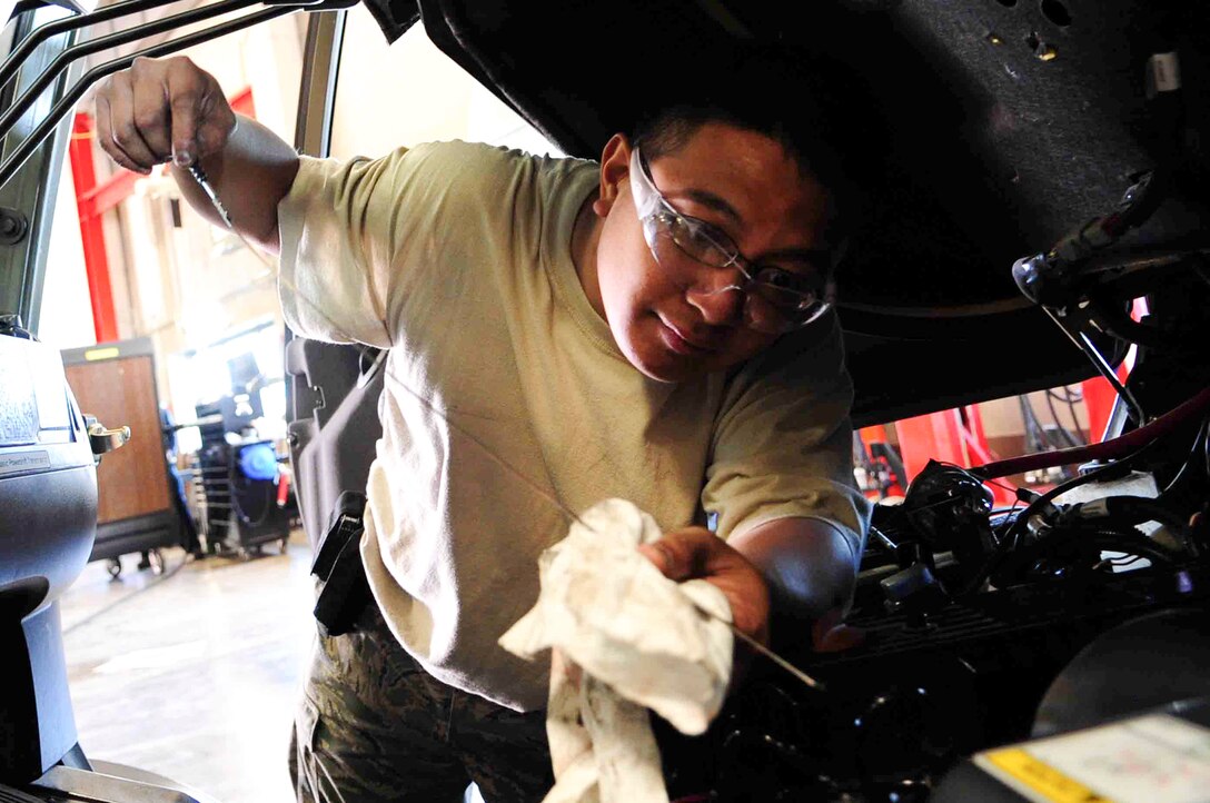 ELLSWORTH AIR FORCE BASE, S.D. – Staff Sgt. Agustin Tabita, 28th Logistics Readiness Squadron vehicle and vehicular equipment maintenance journeyman, checks the oil of a forklift, July 16. The vehicle maintenance shop routinely changes oil on government vehicles base wide. (U.S. Air Force Photo/Airman 1st Class Corey Hook)