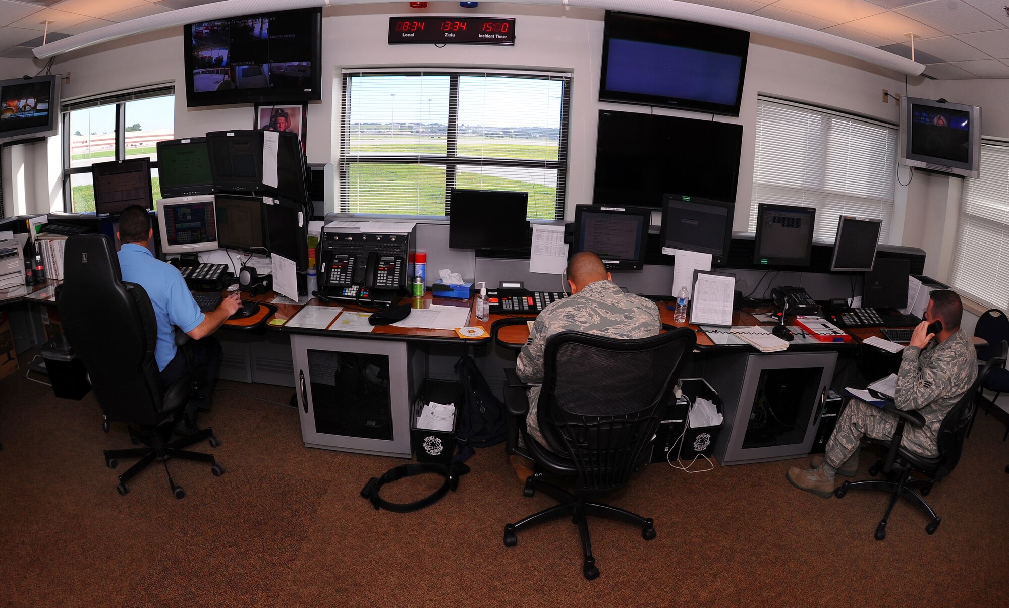 OFFUTT AIR FORCE BASE, Neb. - Offutt Fire Department and 55th Security Forces dispatchers work side by side taking calls July 15 in the new Emergency Communications Center located within the firestation. The ECC was stood up June 29, placing both fire and law enforcement dispatches in a central location to create stronger situational awareness between the two departments. U.S. Air Force photo by Josh Plueger
