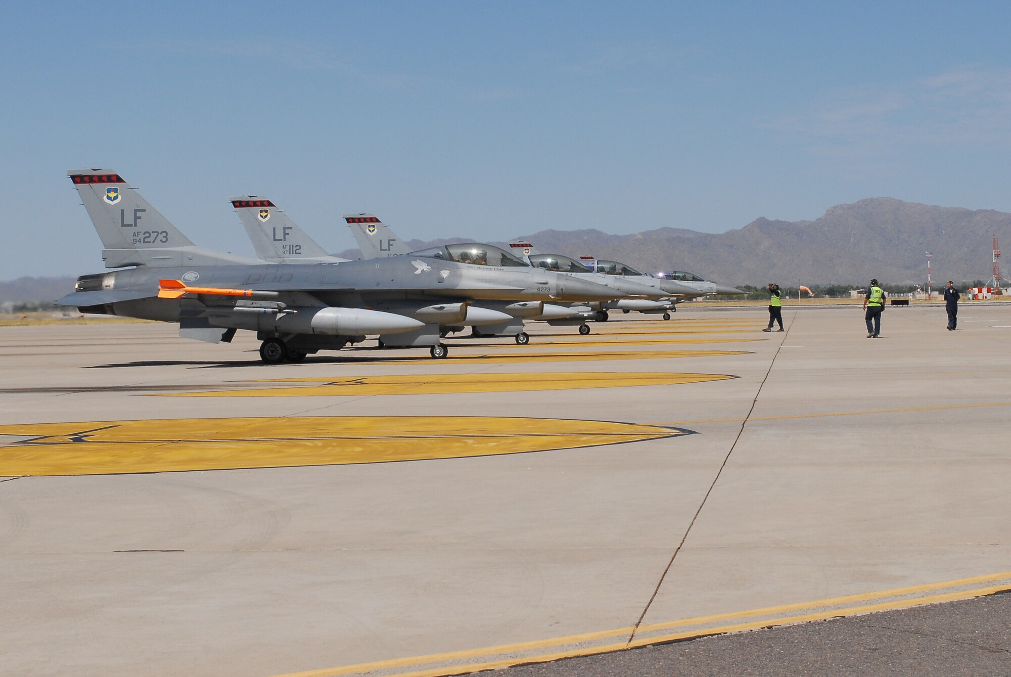 Luke Air Force Base crew chiefs make final checks on four F-16 Fighting
Falcons from the 425th Fighter Squadron prior to takeoff July 12.  On
average, Luke pilots fly about 113 training missions per day.  (Air Force
photo/Senior Airman Tracie Forte)
