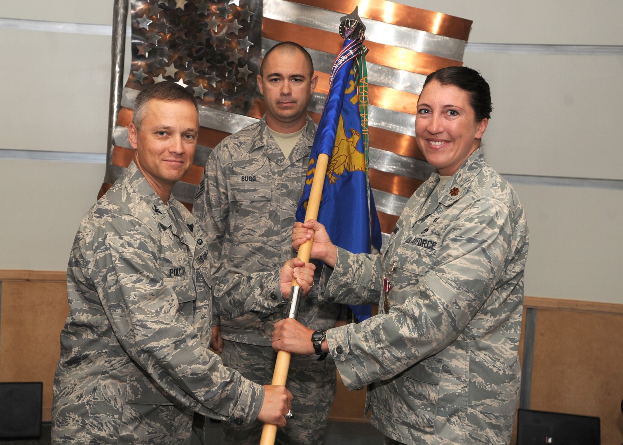 Major Sarah Williams relinquishes command of the 319th Maintenance Operations Squadron over to Col. Henry Polczer, 319th Operations Group commander July 16. 319th MOS will become a flight until a new flying mission returns to Grand Forks AFB. (U.S. Air Force Photo by Staff Sgt. Suellyn F. Nuckolls)