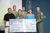 Members of the Kitty Hawk Airlift Tanker Association presented college scholarships to two Wayne County seniors on July 13. (USAF photo by SSgt. Terrica Jones, 916ARW/PA)
