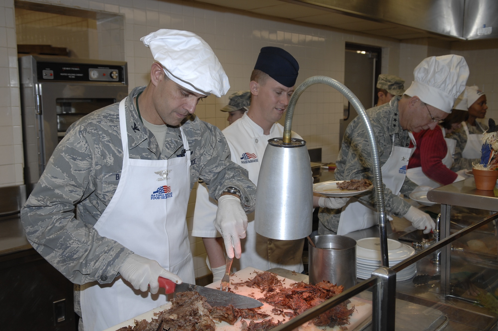 BARKSDALE AIR FORCE BASE, La. – Col. Steven Basham, 2d Bomb Wing commander, helps serve food at the Red River Dining Facility November 26, during the Thanksgiving Day feast for Airmen who are unable to visit their families for the holiday. (U.S. Air Force photo by Airman 1st Class Joesph Boals) 