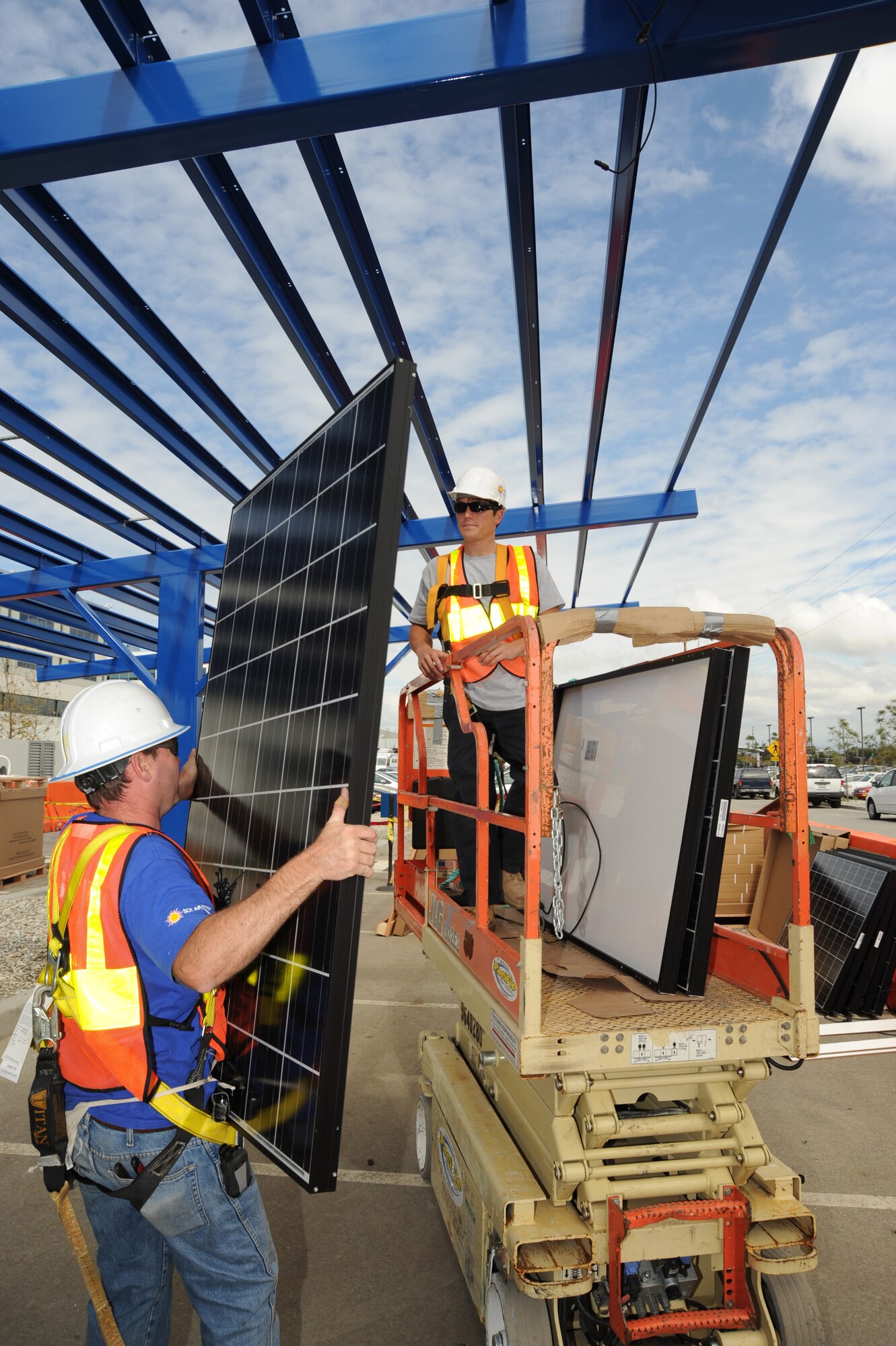 Work continues on the solar panels being installed on Los Angeles Air Force Base, Calif. When completed, the panels will decrease the amount of electricity the base purchases from the local power company. A similar project on the roof of the base commissary converts sunshine into about 290 kilowatt-hours of electricity each day, enough to power 10 typical households. (U.S. Air Force photo/Lou Hernandez) 