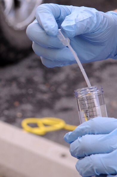BARKSDALE AIR FORCE BASE, La-- Senior Airman Laura Heineman, 2d Civil Engineer Squadron emergency management, tests for positive or negative readings for biological warfare agents after testing filters from a dry filter unit as part of the Chemical, biological, radiological, nuclear and high-yield explosives, or CBRNE, challenge. The exercise trained bioenvironmental and emergency managements teams on overall response to hazardous incidents. (U.S. Air Force photo/Airman 1st Class Allison M. Boehm) (RELEASED)