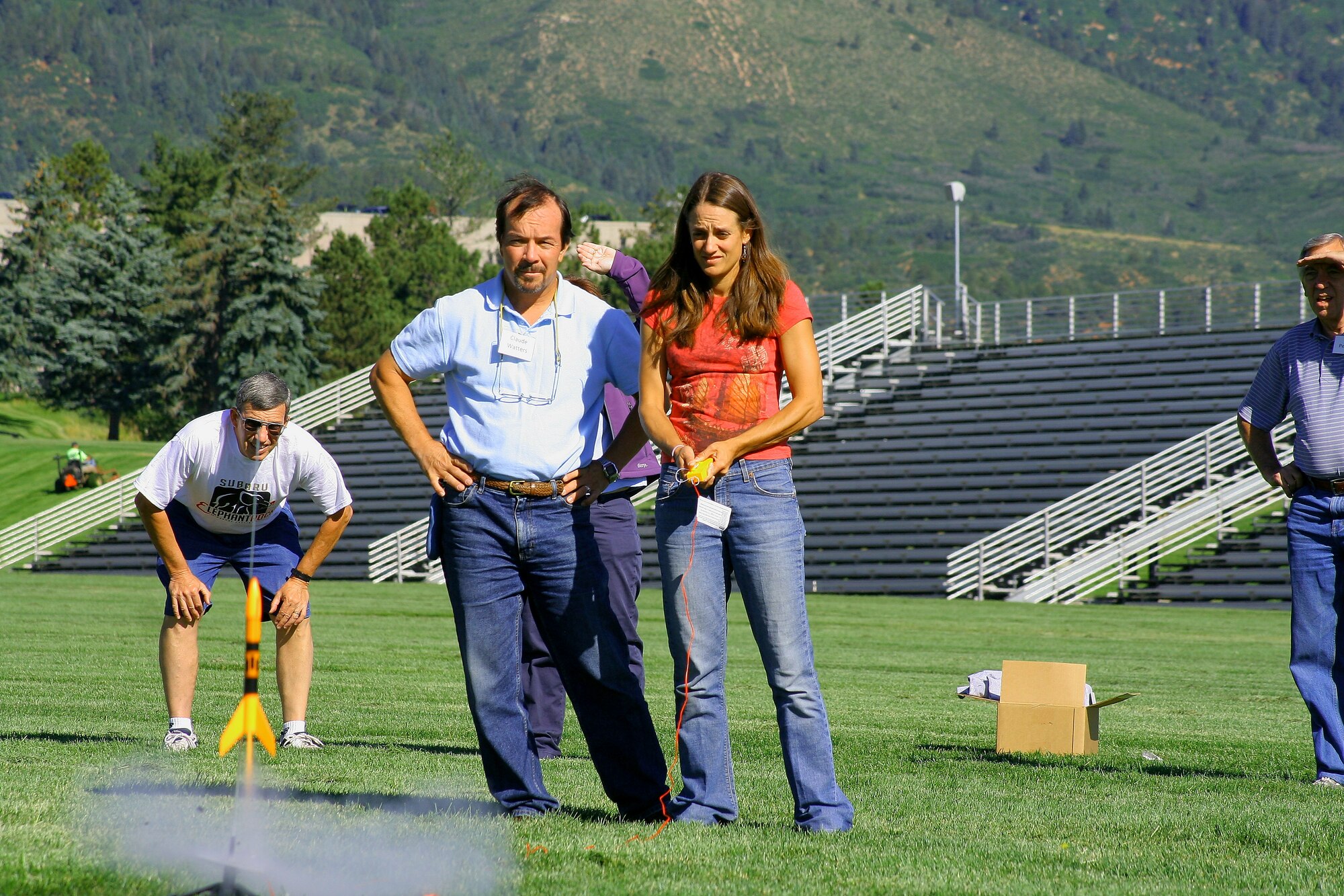 Teachers Claude Watters, center, and Emily Anderson launch their Estes rocket during a three-day Space Technology Applications Reaching Students teacher training workshop July 9, 2010. Mr. Watters is a teacher with The Classical Academy in Academy School District 20. Ms. Anderson is a teacher at Sierra High School in Harrison School District 2. (U.S. Air Force photo/Julie Imada)