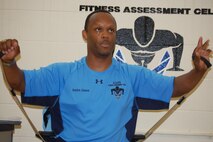 Brandon Johnson, full-time staff in the Fitness Assessment Cell, shows how bands can be used while sitting at your desk to tone and strengthen muscles. (USAF photo by Maj. Shannon Mann, 916ARW/PA)