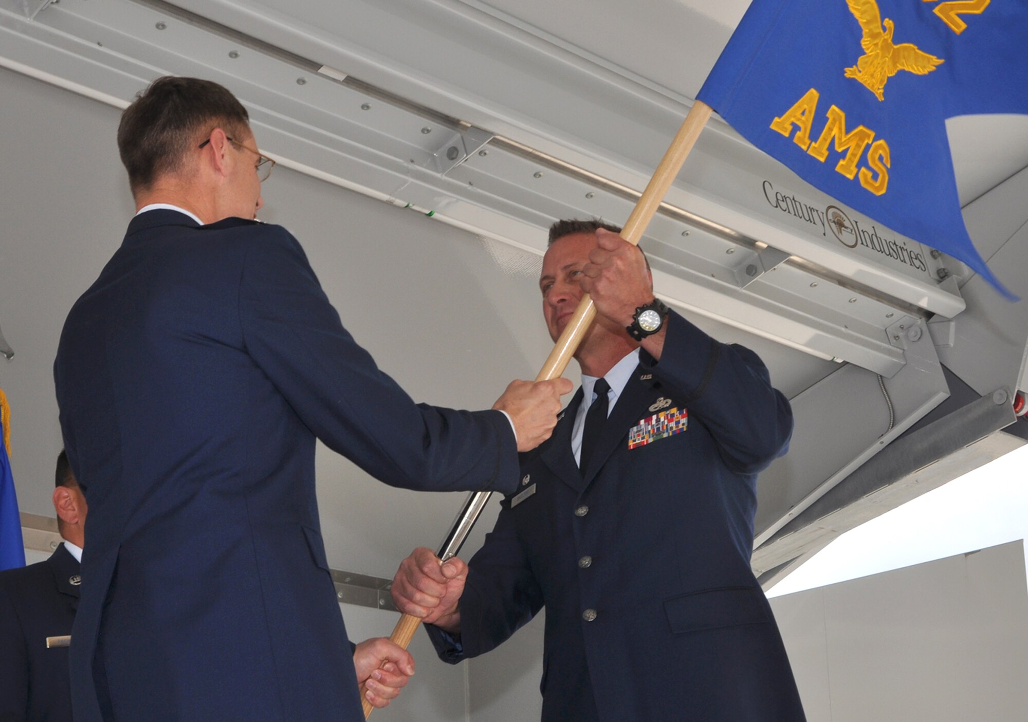 Capt. Collin "Bo" Shelton (right) takes the 302nd Aircraft Maintenance Squadron guidon from Col. James Van Housen, 302nd Maintenance Group commander, as he assumed command of the squadron during a July 11 ceremony at Peterson Air Force Base, Colo. "Captain Shelton has strong leadership and embodies Air Force core values," said Colonel Van Housen. "There is a promising future for [the] aircraft maintenance squadron with Captain Shelton as [its] commander." (U.S. Air Force photo/Tech. Sgt. Daniel Butterfield)