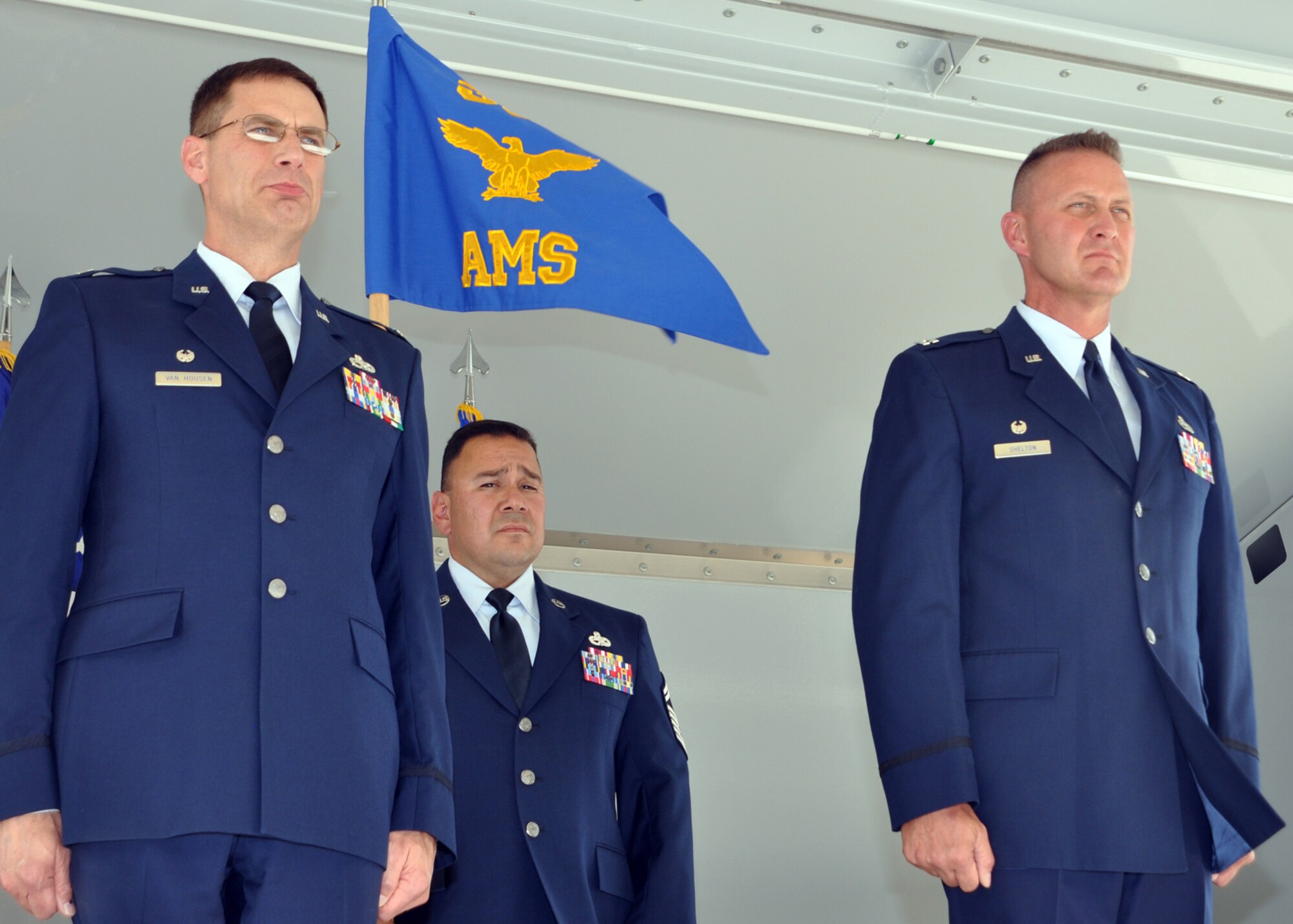 Col. James Van Housen, 302nd Maintenance Group commander (left) prepares to take the guidon from Senior Master Sgt. Robert Pacheco (background) and offer it to Capt. Collin "Bo" Shelton, who assumed command of the 302nd Aircraft Maintenance Squadron during a July 11 ceremony at Peterson Air Force Base, Colo. "I hold our people to the highest standards, including myself," said Captain Shelton after taking command. "We want to be the standard everyone else measures up to." Sergeant Pacheco is the 302nd MXG first sergeant. (U.S. Air Force photo/Tech. Sgt. Daniel Butterfield)
