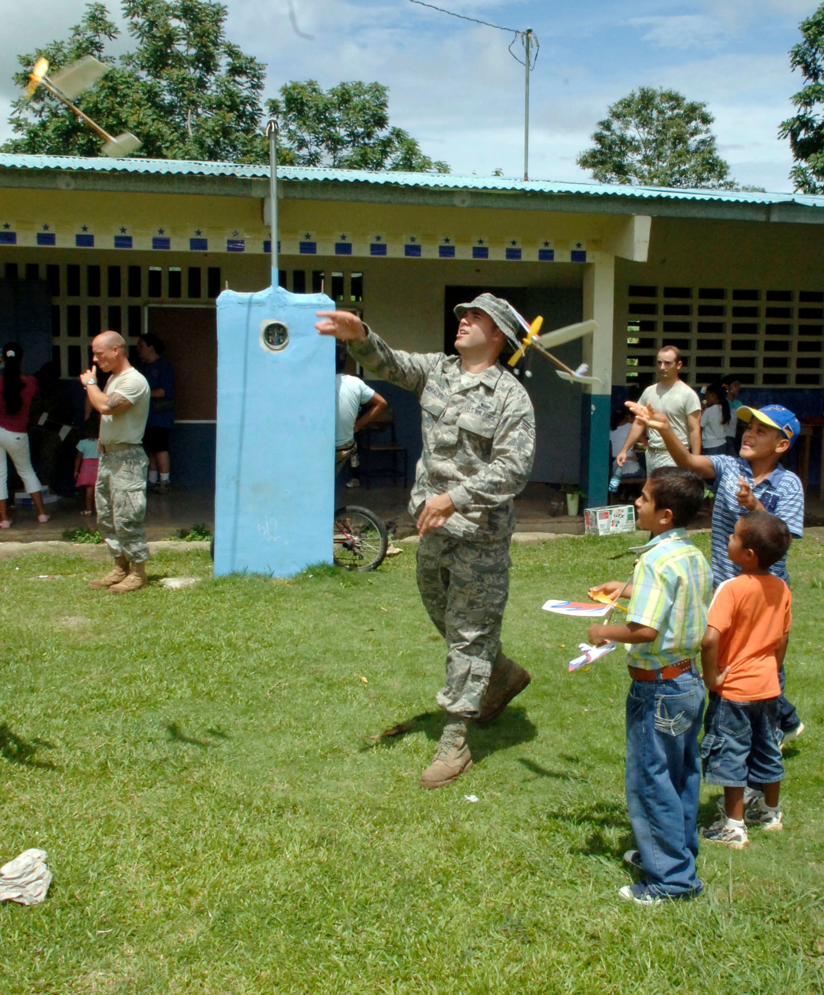 Senior Airman Cesar Morales launches rubber-band airplanes with students July 12, 2010, at the Sansonsito School in Panama. Airman Morales is assigned to the 820th Expeditionary RED HORSE Squadron. (U.S. Air Force photo/Tech. Sgt. Eric Petosky)
