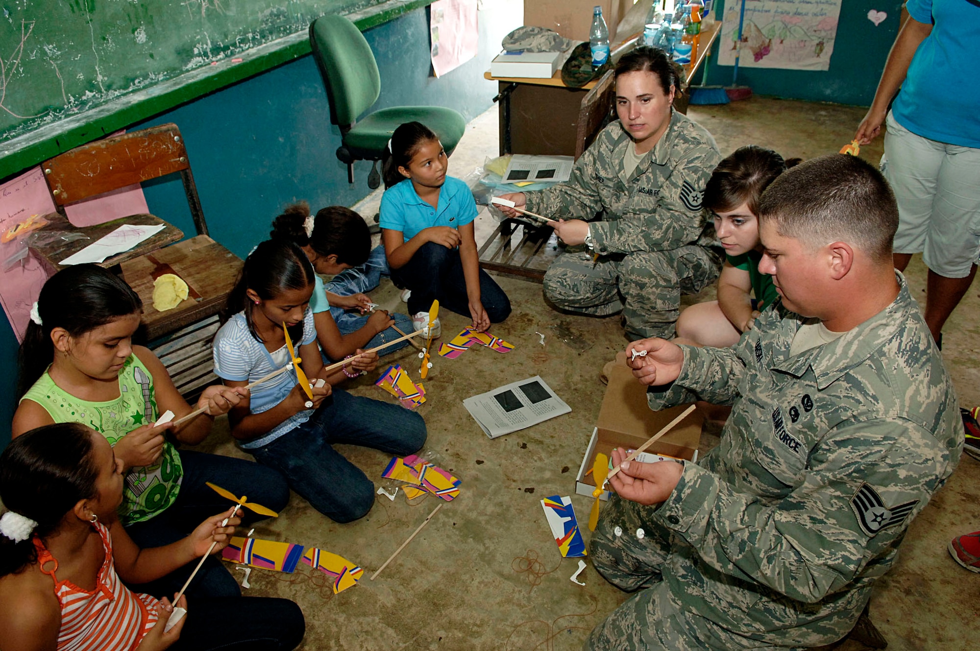 Tech. Sgt. Dorothy Lanthier and Staff Sgt. Josh Lazarski help children assemble rubber-band airplanes July 12, 2010, at the Sansonsito School in Panama. Sergeants Lanthier and Lazarski are assigned to 820th Expeditionary RED HORSE Squadron. (U.S. Air Force photo/Tech. Sgt. Eric Petosky)