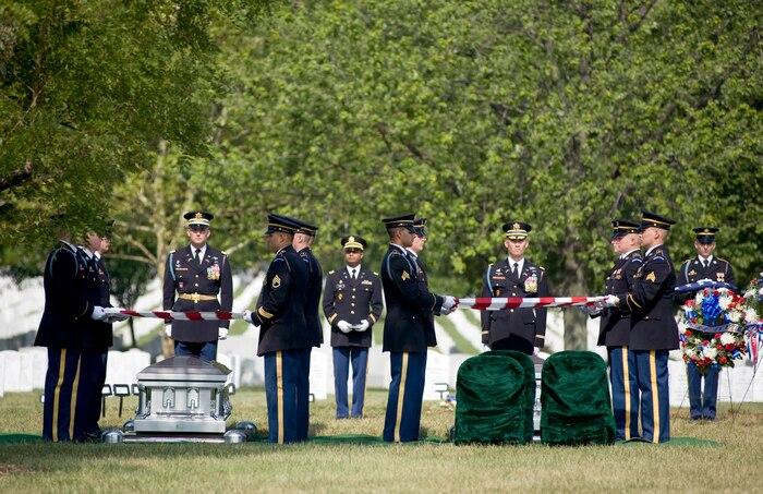 Soldiers from The Old Guard prepare to fold two American flags that were draped over two caskets containing the remains of seven Airmen who died in Burma in 1944 July 15, 2010 at Arlington National Cemetery, Va. (DOD photo/Michael Tolzmann)