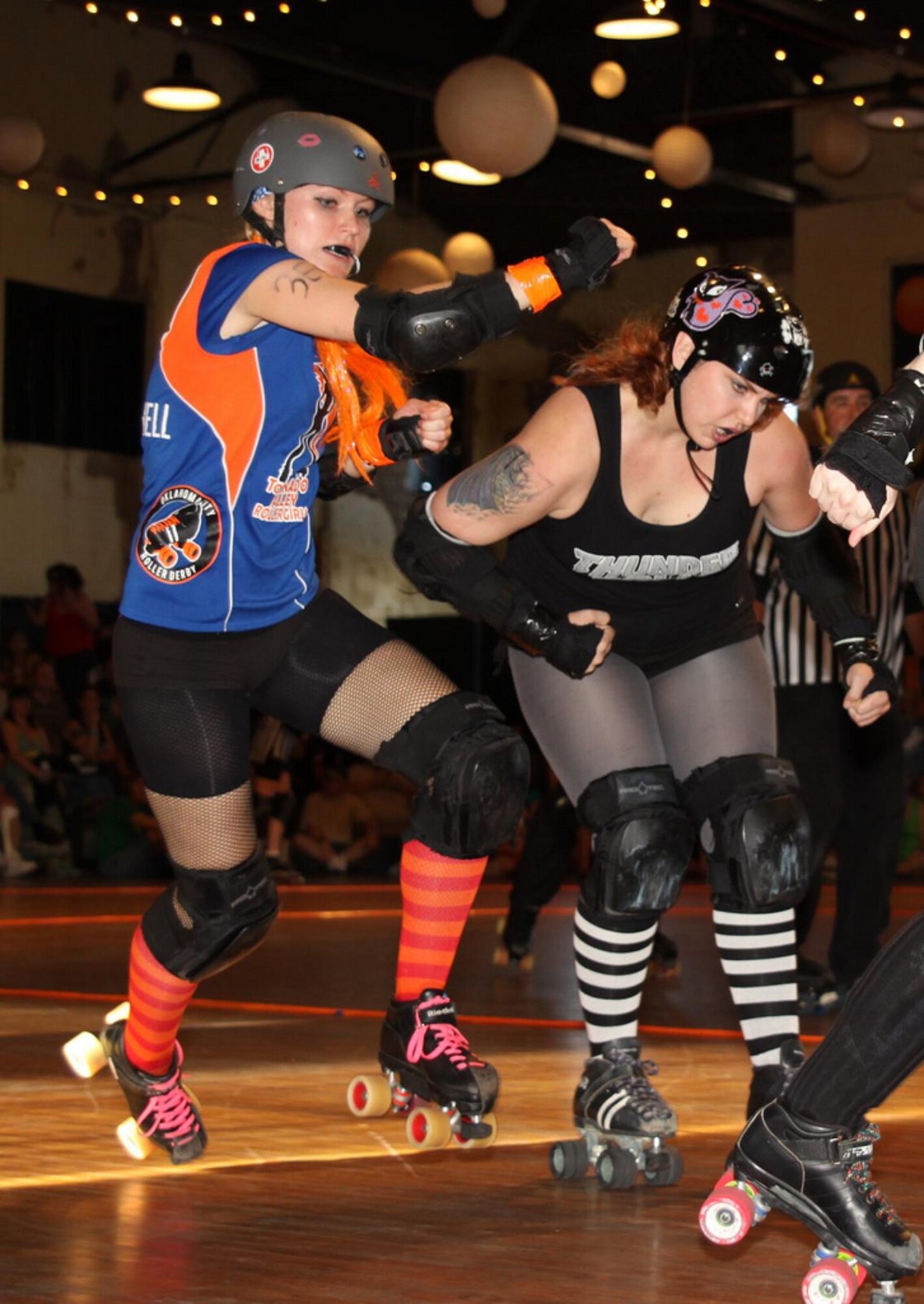 Long-distance runner Jamie Weber, left, was looking to change up her workout routine when she attended her first roller derby bout. Though she’s just playing in her first year, the engineer with the 72nd Air Base Wing Civil Engineering Directorate, has a reputation as one of the best jammers on her team. (Courtesy photo)