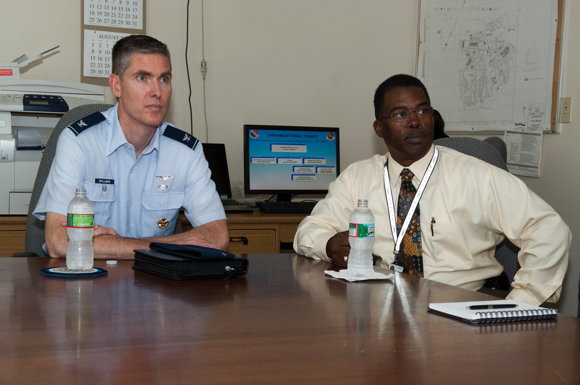 New Electronic Systems Center Vice Commander Col. Mark Spillman sits with 66th Air Base Group Safety Chief Galen Williams while receiving his introductory safety briefing July 13. (U.S. Air Force Photo by Rick Berry)
