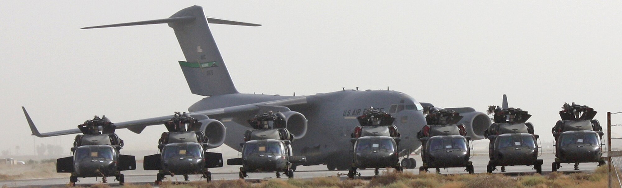 A C-17 Globemaster III pulls onto the parking ramp behind Army UH-60 Blackhawk helicopters waiting for transport July 12, 2010, at Joint Base Balad, Iraq.  As the drawdown and redeployment of assets continues in Iraq, helicopters from bases in the north have made their way to Joint Base Balad to be inspected, prepped and shipped to new operating locations. (U.S. Air Force photo/Staff Sgt. Stacy Fowler)