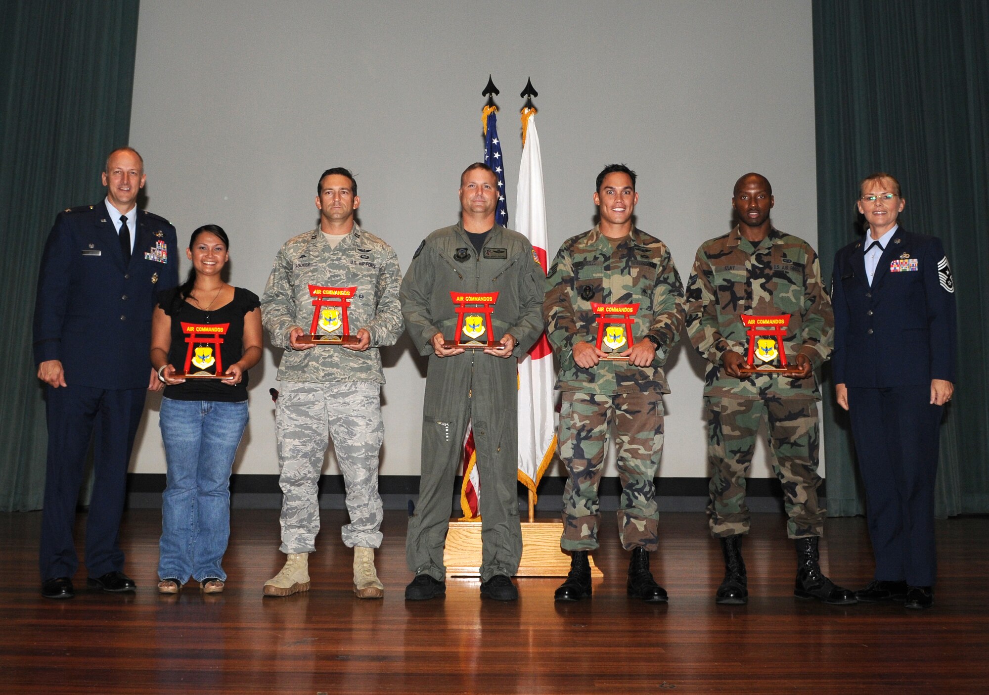 KADENA AIR BASE, Japan -- Col. Robert Toth (far left), 353rd Special Operations Group commander, and Chief Master Sgt. Victoria Gamble (far right), 353rd SOG command chief master sergeant, pose for a photograph with the group's second quarter award winners July 16. The winners are, from left: Irene Jones, Capt. Joseph Booker, Master Sgt. Montgomery DeCarlo, Staff Sgt. Ryan Hatfield, and Senior Airman Jonnathan Clay. (Photo by Tech. Sgt. Aaron Cram)