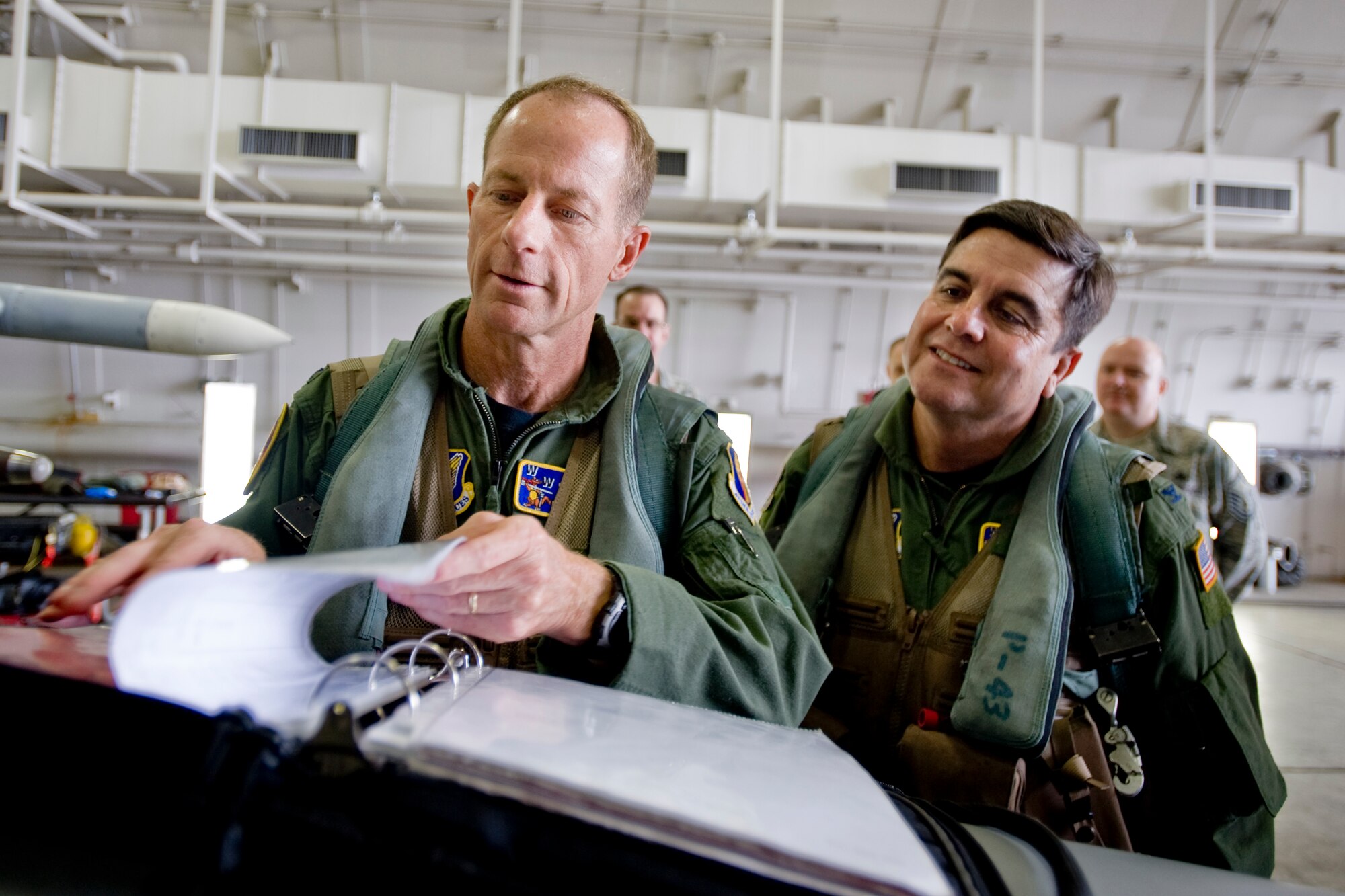 MISAWA AIR BASE, Japan -- Col. David Stilwell, 35th Fighter Wing commander, and Col. Guillermo Tellez, 35th Medical Group commander, review information of an F-16 Fighting Falcon before taking flight July 14. The flight was Colonel Tellez's first in an F-16. (U.S. Air Force photo/Senior Airman Jamal D. Sutter)