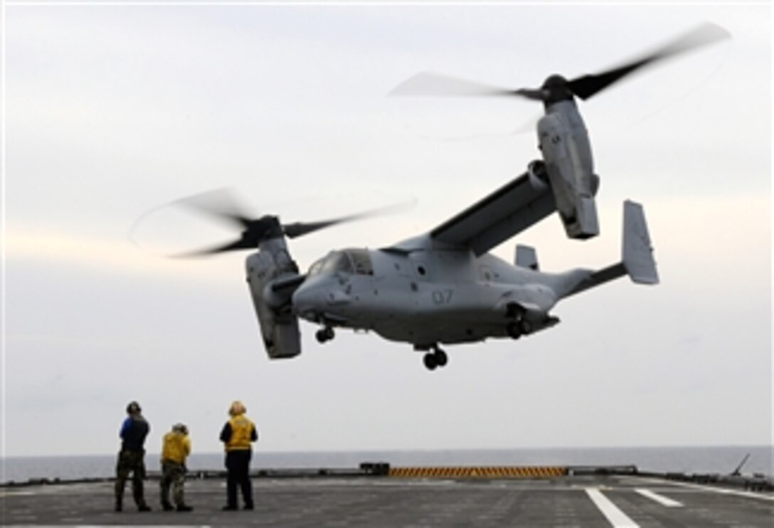 U.S. Navy sailors watch an MV-22A Osprey tilt-rotor aircraft take off from the flight deck of the amphibious transport dock USS Ponce (LPD 15) in the Atlantic Ocean on July 12, 2010.  The Ponce, part of the Kearsarge Amphibious Ready Group, is participating in a composite unit training exercise off the East Coast of the United States.  Composite unit training is designed to provide realistic training environments for U.S. naval forces that closely replicate the operational challenges routinely encountered during military operations around the world.  