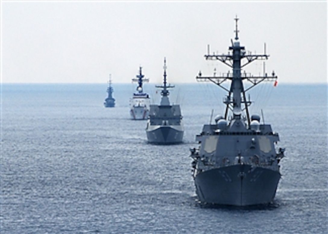 The guided missile destroyer USS Chung-Hoon (DDG 93), Singapore frigate RSS Steadfast (FFG 70), high endurance cutter USCGC Mellon (WHEC 717) and Singapore corvette RSS Vigilance (90) line up during a surface gunnery exercise in the South China Sea on July 12, 2010.  The U.S. and Singapore navies were participating in Cooperation Afloat Readiness and Training Singapore 2010.  Cooperation Afloat Readiness and Training is a series of bilateral exercises held annually in Southeast Asia.  