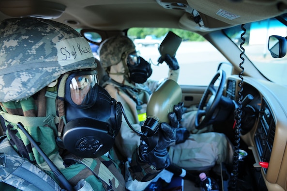 U.S. Air Force Staff Sgt. Christopher Ricks and Airman 1st Class Francisco Chavez both from the 86th Security Forces Squadron, drink water from canteens while in Mission Oriented Protective Posture (MOPP) 4, Ramstein Air Base, Germany, July 18, 2010. An ORE incorporates a series of scenarios to evaluate a base's ability to execute operational duties under simulated wartime conditions. (U.S. Air Force photo by Airman 1st Class Desiree Esposito)