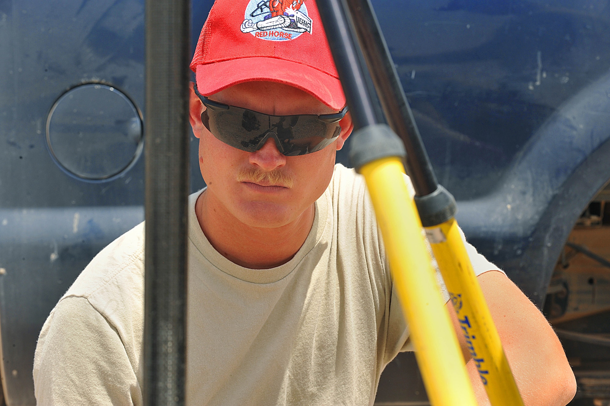 U.S. Air Force Senior Airman Joseph Carbary watches as corrections are being made during a survey alignment on an unfinished runway at Camp Dwyer, Afghanistan, June 25, 2010.  The runway will be used to accommodate heavier aircraft at Camp Dwyer.  Sergeant Walsh is an engineer deployed 809th Expeditionary Red Horse Squadron.  (U.S. Air Force photo/Staff Sgt. Quinton Russ/released)