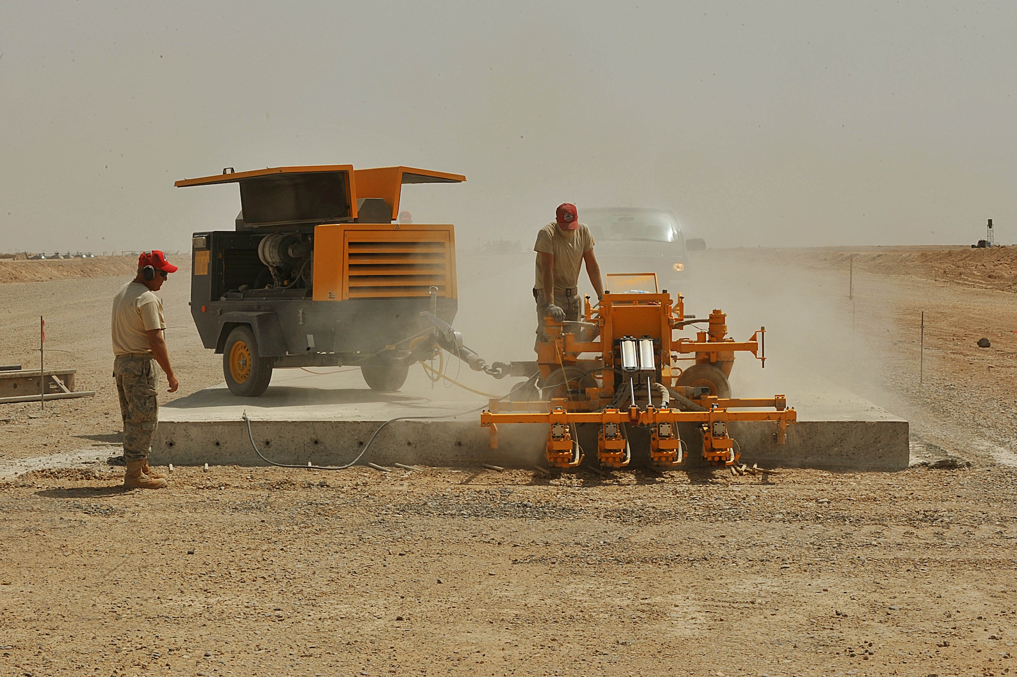 U.S. Air Force Staff Sgt. Derek Phelps drills dowel holes into an unfinished runway at Camp Dwyer, Afghanistan, June 25, 2010.  The runway will be used to accommodate heavier aircraft at Camp Dwyer.  Sergeant Phelps is a heavy equipment operator and deployed to the 809th Expeditionary Red Horse Squadron.  (U.S. Air Force photo/Staff Sgt. Quinton Russ/released)