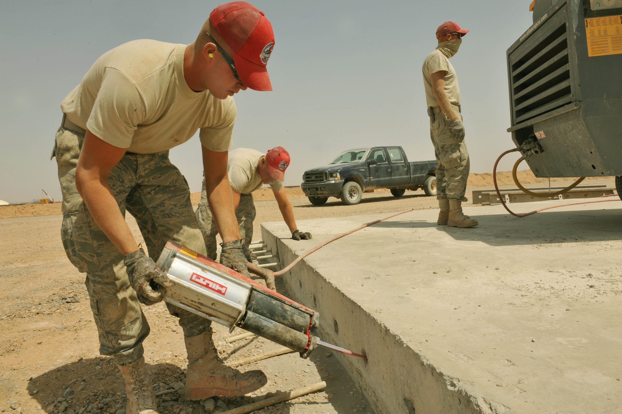 U.S. Air Force Tech. Sgt. Mark Schneider puts an epoxy sealant into holes of an unfinished runway at Camp Dwyer, Afghanistan, June 25, 2010.  The runway will be used to accommodate heavier aircraft at Camp Dwyer.  Sergeant Schneider is a heavy equipment operator deployed to the 809th Expeditionary Red Horse Squadron.  (U.S. Air Force photo/Staff Sgt. Quinton Russ/released)