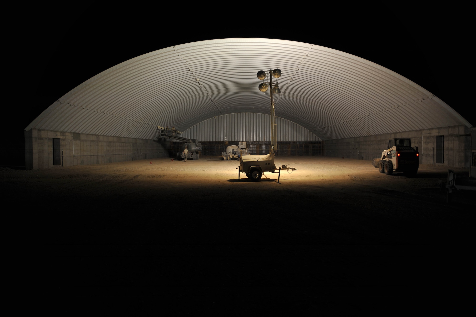 Airman from the 809th Expeditionary Red Horse Squadron put finish on a KSPAN hangar at Camp Dwyer, Afghanistan, June 24, 2010.  The hanger will be used to accommodate heavier aircraft at Camp Dwyer.  (U.S. Air Force photo/Staff Sgt. Quinton Russ/released)