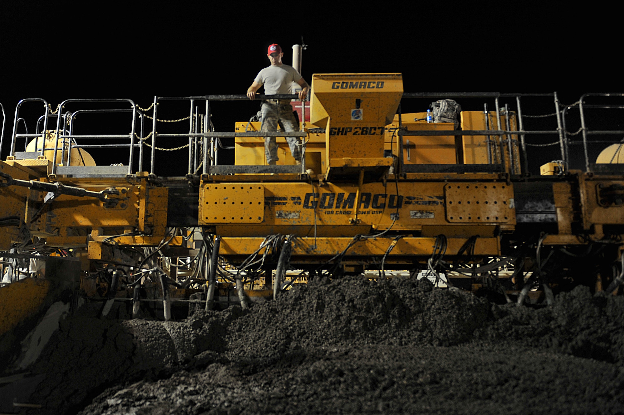 U.S. Air Force Senior Airman Jarred Walp uses a paver to smooth out newly poured cement on an unfinished runway at Camp Dwyer, Afghanistan, June 24, 2010.  The runway will be used to accommodate heavier aircraft at Camp Dwyer.  Airman Walp is a heavy equipment operator deployed to the 809th Expeditionary Red Horse Squadron.  (U.S. Air Force photo/Staff Sgt. Quinton Russ/released)