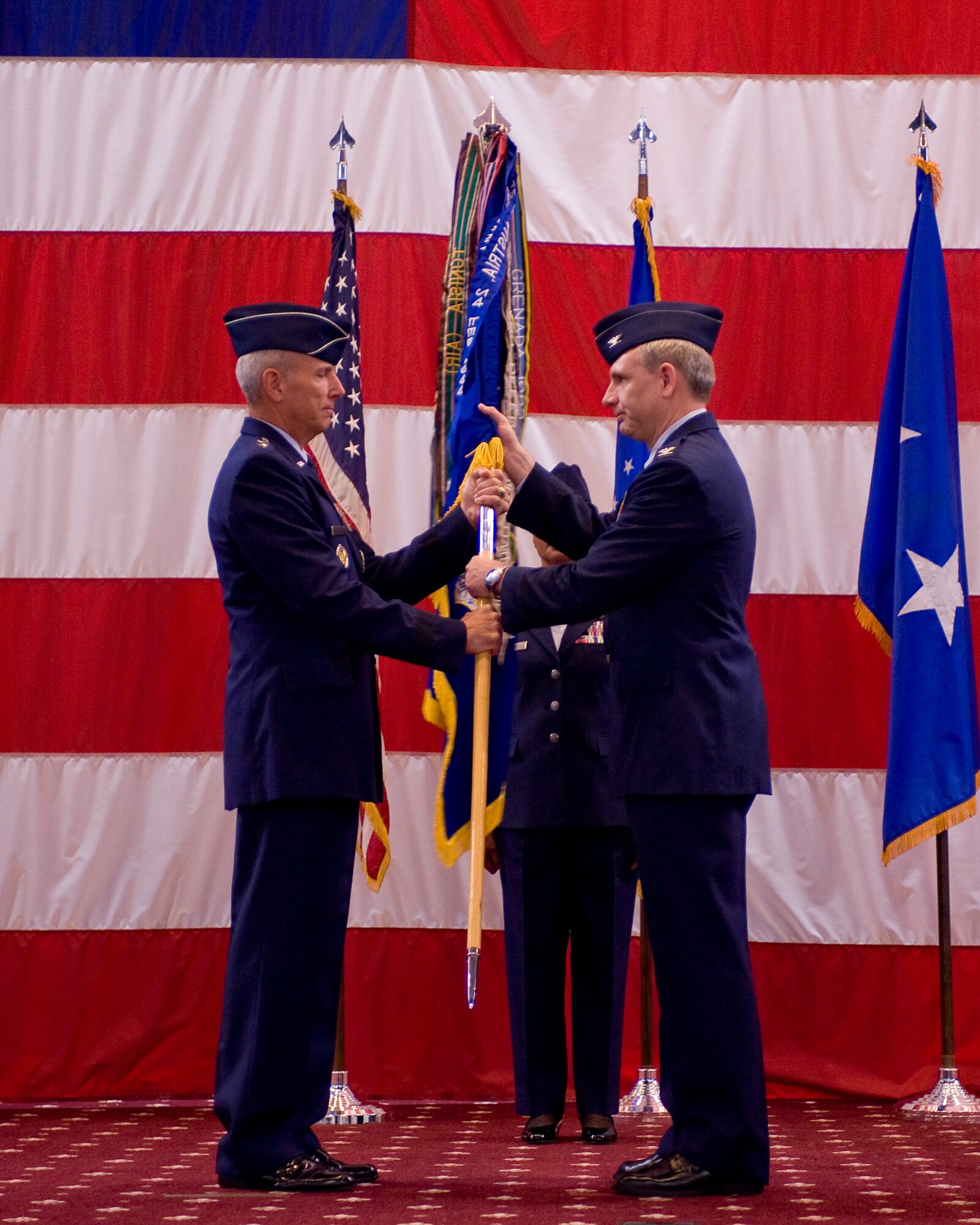 BARKSDALE AIR FORCE BASE, La. -- Col. Timothy Fay (right), accepts the 2d Bomb Wing guidon from Maj. Gen. Floyd Carpenter, Eighth Air Force commander, to signify his assumption of command during the wing change-of-command ceremony July 19. The passing of command is one deeply rooted in military tradition, dating back to the Norman Conquest of England. It serves as a visible means of handing the reins of command to the new commander. As the unit flag or guidon is exchanged, it represents the responsibility associated with the unit being surrendered and accepted. Colonel Fay took over command from Colonel Steven Basham. (U.S. Air Force photo by Senior Airman Chad Warren)(RELEASED)