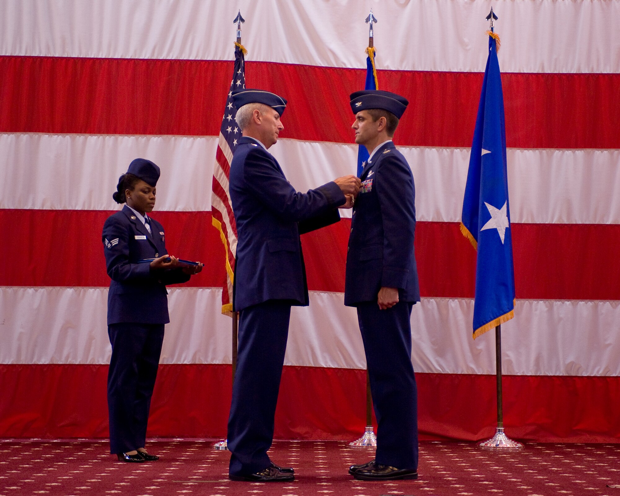BARKSDALE AIR FORCE BASE, La. -- Maj. Gen. Floyd Carpenter, Eighth Air Force commander, presents the Legion of Merit to Col. Steven Basham, outgoing 2d Bomb Wing commander, during the wing change-of-command ceremony July 19. The passing of command is one deeply rooted in military tradition, dating back to the Norman Conquest of England. It serves as a visible means of handing the reins of command to the new commander. As the unit flag or guidon is exchanged, it represents the responsibility associated with the unit being surrendered and accepted. Colonel Basham relinquished command to Colonel Timothy Fay. (U.S. Air Force photo by Senior Airman Chad Warren)(RELEASED)