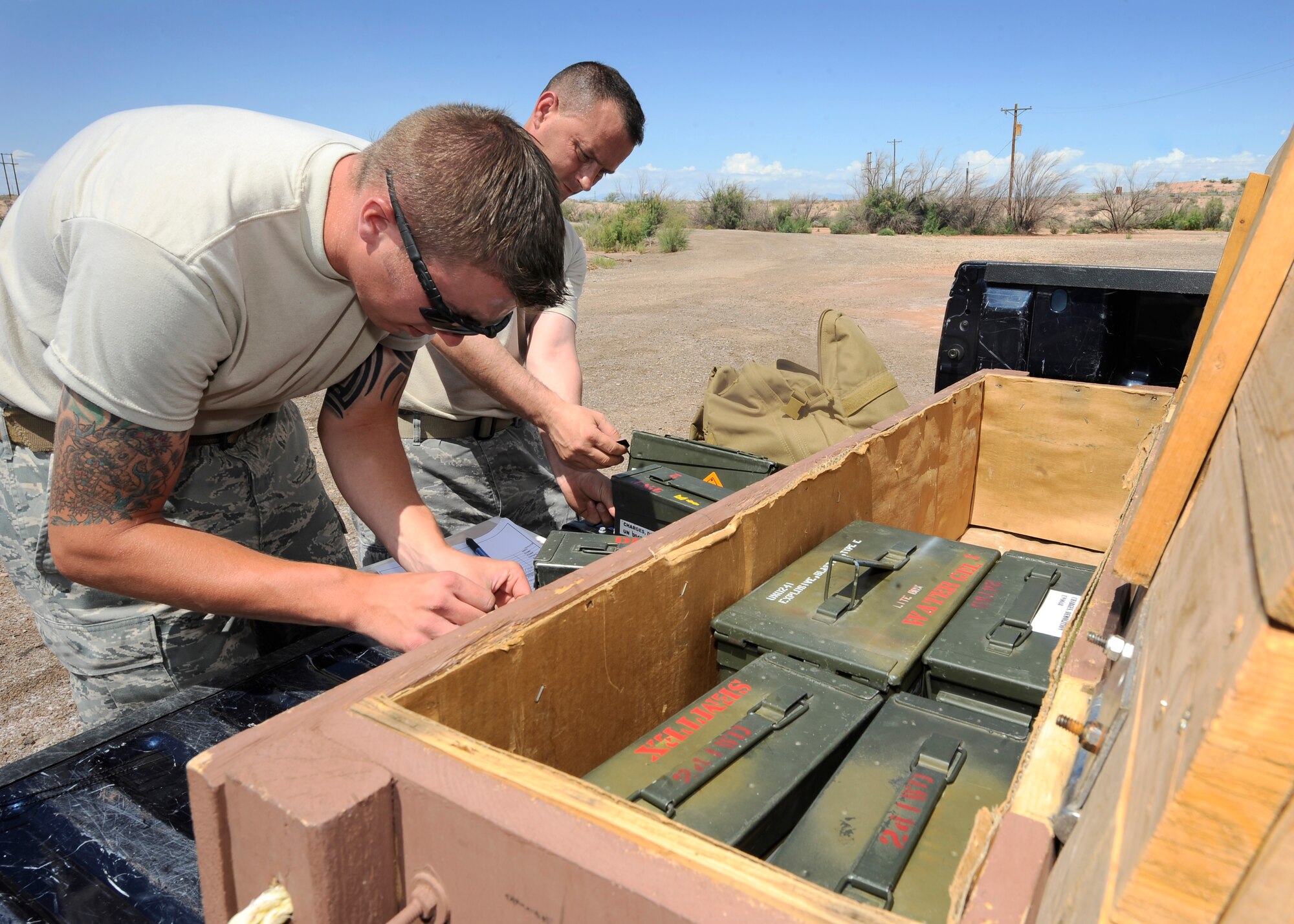 HOLLOMAN AIR FORCE BASE, N.M. -- Tech. Sgt. Ross Morgan and Staff Sgt. Joel Munson, both from the 49th Security Forces Squadron Military Training Dog Section, account for the military working dog scent kit at the end of the detection training June 8, 2010. Airmen from the MWD team train their assigned dogs to ensure proficiency in patrol, controlled aggression and obedience training. (U.S. Air Force photo by Senior Airman Veronica Stamps / Released)