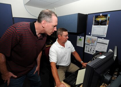 Internet advisors Dale Adermann (left) and Gregg Sparks, respond to a propective Air Force recruit's questions online June 19 at Randolph Air Force Base, Texas. The Air Force Recruiting Service's "chatters" are available to answer questions about the Air Force. (U.S. Air Force photo/Dave Terry)