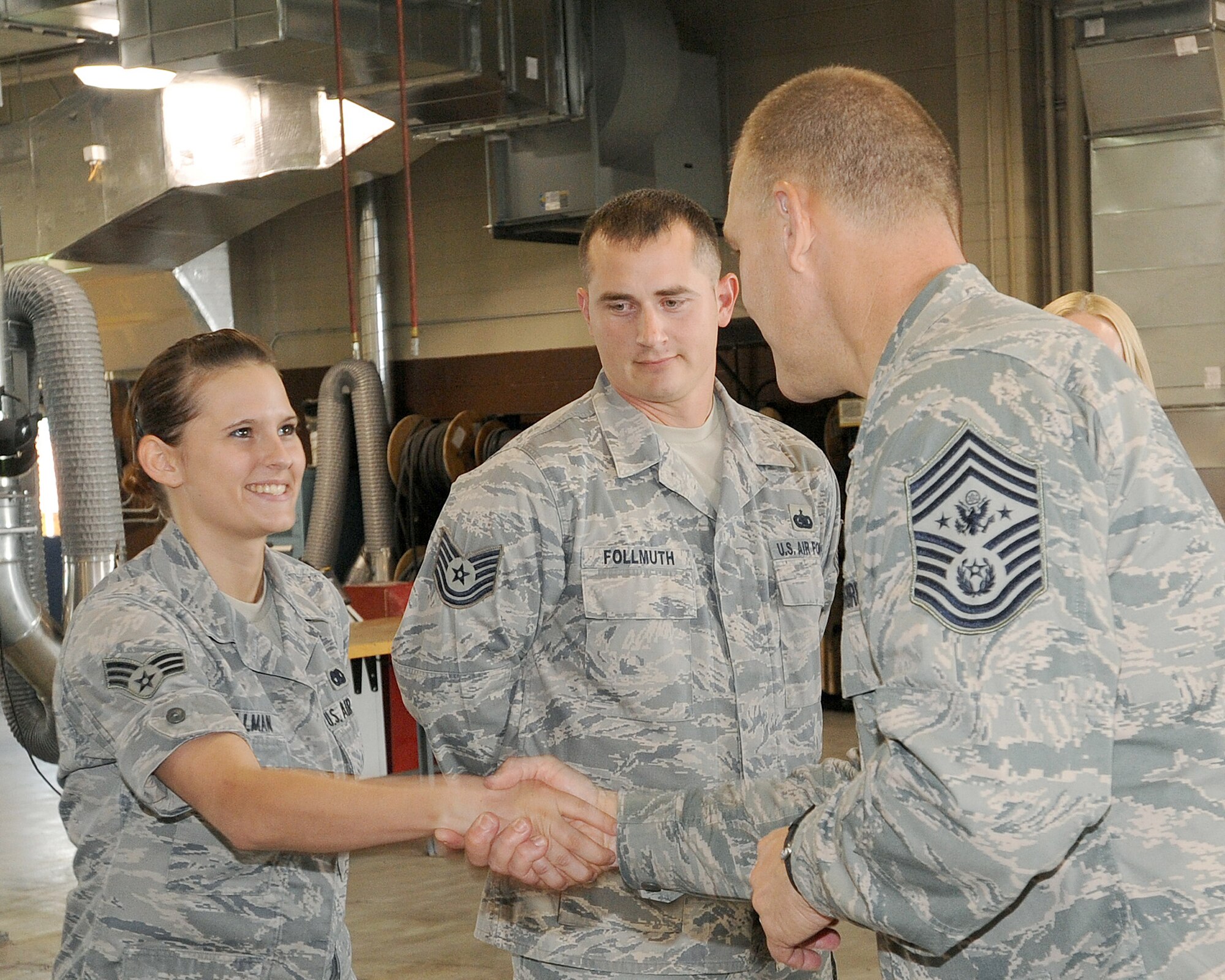 Senior Airman Jolene Bollman shakes hands with Chief Master Sgt. of the Air Force James A. Roy's July 15, 2010 at Grand Forks Air Force Base, N.D. Chief Roy met with Airmen from the 319th Air Refueling Wing and toured base facilities, which allowed him to see Airmen here prepare for the transition to a new mission. Airman Bollman is assigned to the 319th Logistics Readiness Squadron. (U.S. Air Force photo/Tech. Sgt. Johnny Saldivar)