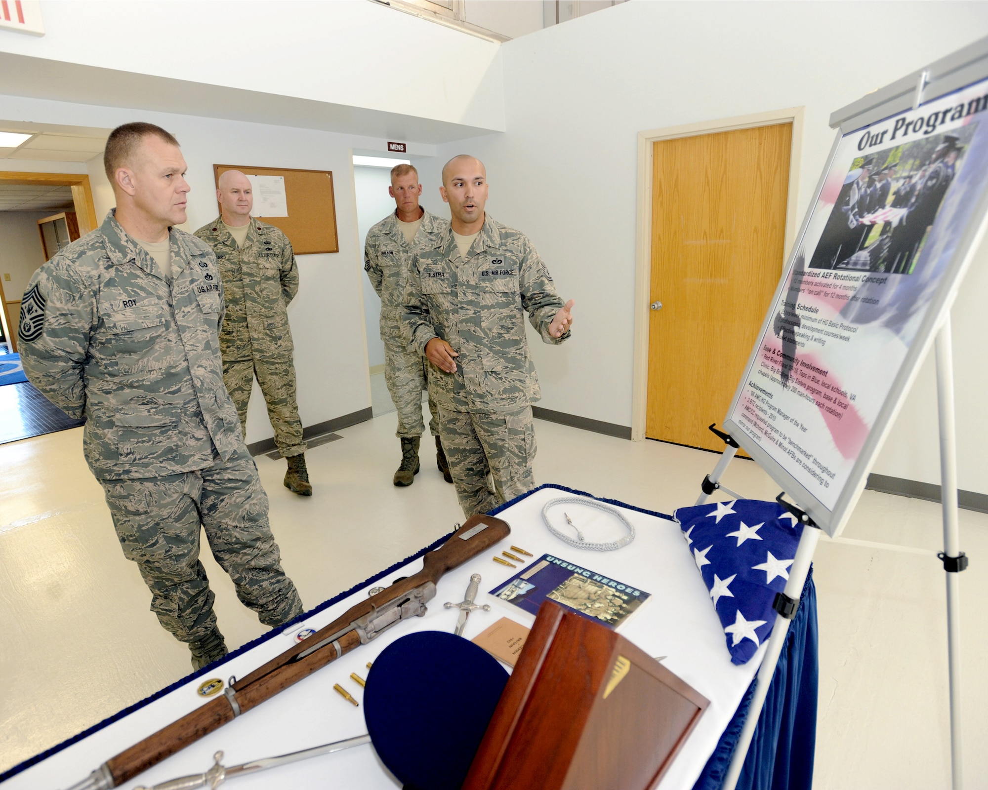 Tech. Sgt. Christopher Tilstra, 319th Force Support Squadron, explains the Grand Forks Air Force Base Honor Guard program to Chief Master Sgt. of the Air Force James A. Roy during a base visit July 14 to 16. (U.S. Air Force photo/Tech. Sgt. Johnny Saldivar)