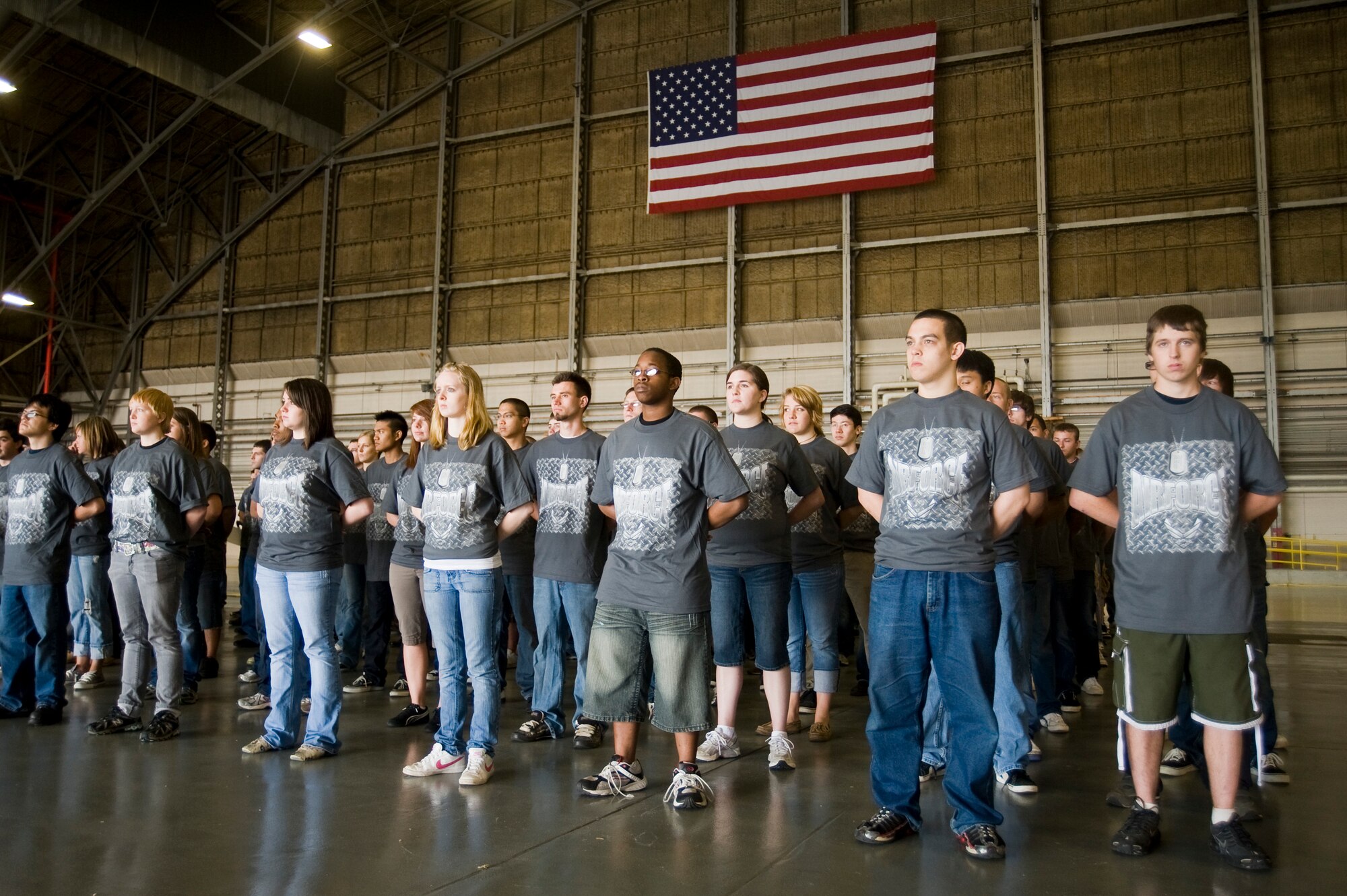 Members of the 361st Recruiting Squadron Delayed Entry Program wait for direction before participating in a record breaking enlistment ceremony July 17 at McChord Field. Col. Kevin Kilb, 62nd Airlift Wing commander, administered the oath of enlistment to 201 future Airmen as part of the JBLM 2010 Air Expo festivities. (U.S. Air Force Photo/Abner Guzman)