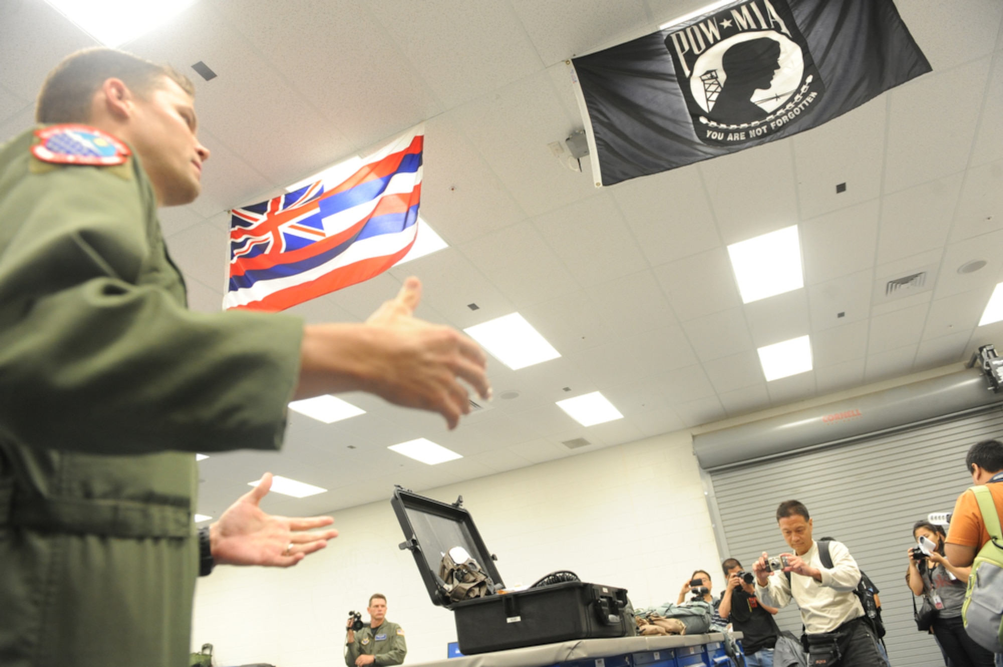 Capt. Chris Keller briefs local Hawaiian bloggers about the duties of life support Airmen July 16, 2010 at Joint Base Pearl Harbor-Hickam, Hawaii. Captain Keller is from the 15th Operation Support Squadron. (U.S.  Air Force
photo/Tech Sgt. Cohen A. Young)
