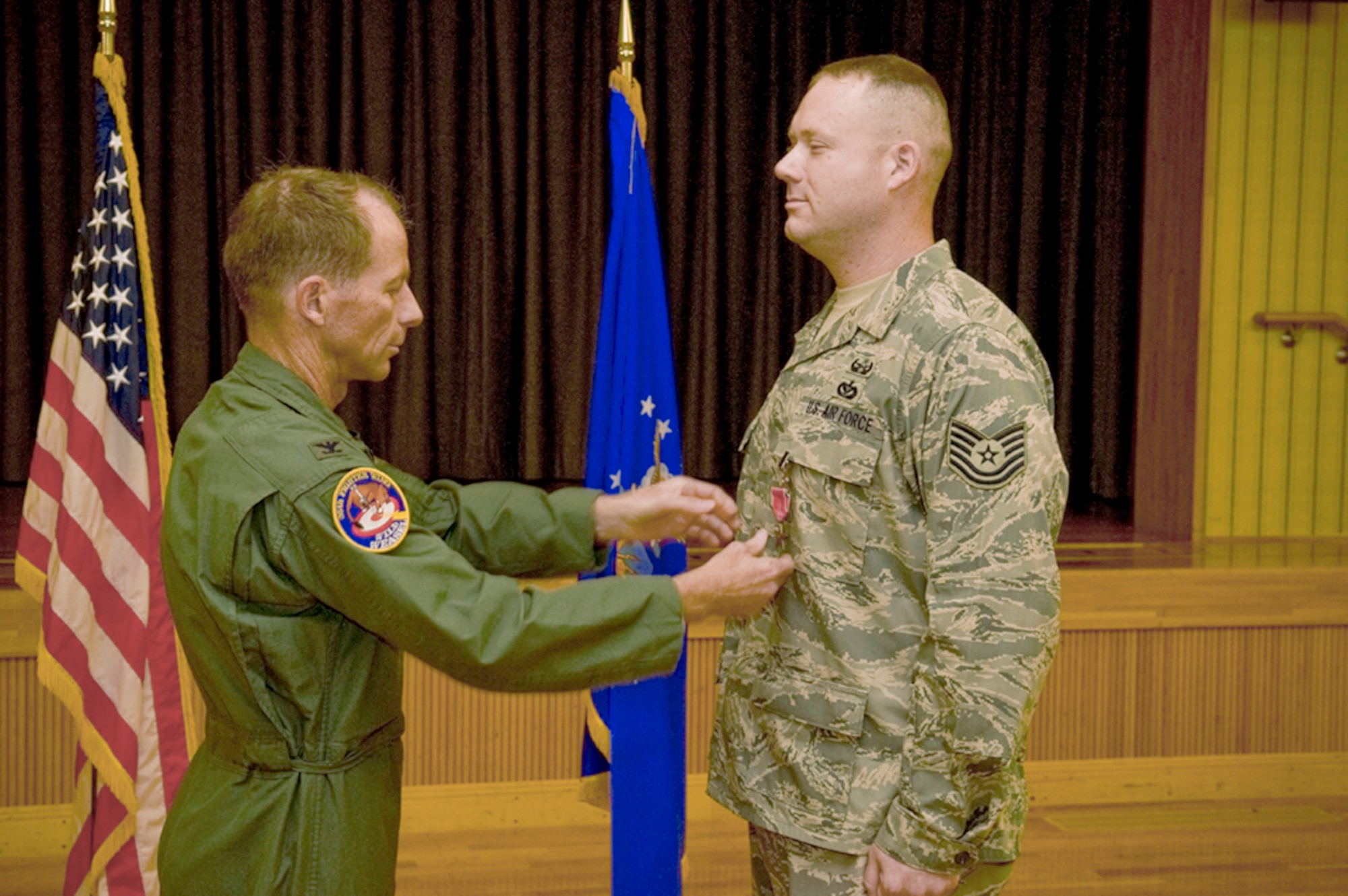 Tech. Sgt. Rory Stark receives a Bronze Star medal from Col. David Stilwell July 2, 2010 at Misawa Air Base, Japan, for his actions in Afghanistan. Sergeant Stark is an explosive ordnance disposal technician assigned to the 35th Civil Engineer Squadron and Colonel Stilwell is the 35th Fighter Wing commander. (U.S. Air Force photo/Senior Airman Jessica Lockoski) 