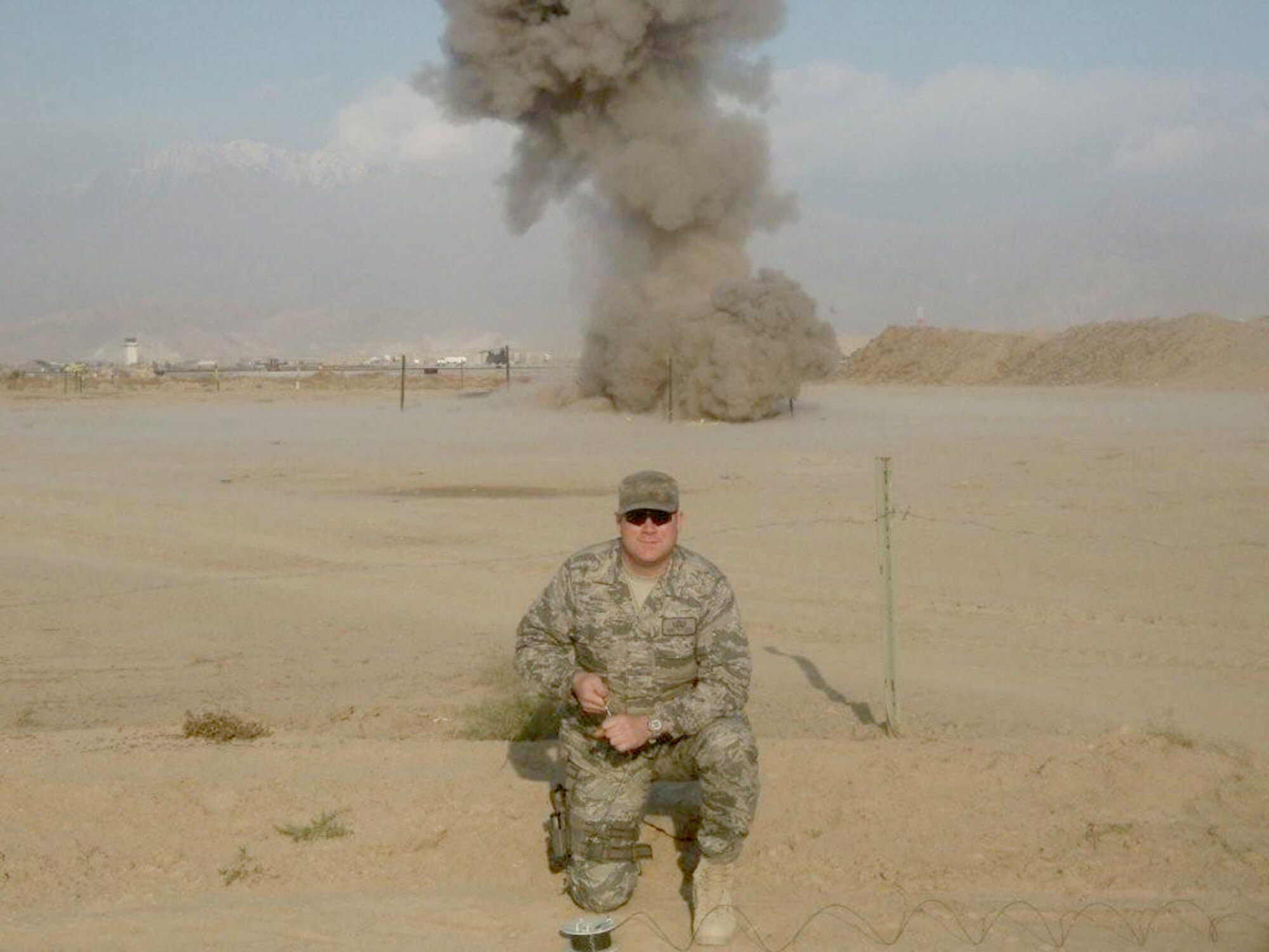 Tech. Sgt. Rory Stark, 35th Civil Engineer Squadron explosive ordnance disposal technician, kneels in front of a blast field while destroying landmines at Bagram Airfield, Afghanistan, during his last deployment. Sergeant Stark is an explosive ordnance disposal technician assigned to the 35th Civil Engineer Squadron. (Courtesy photo) 