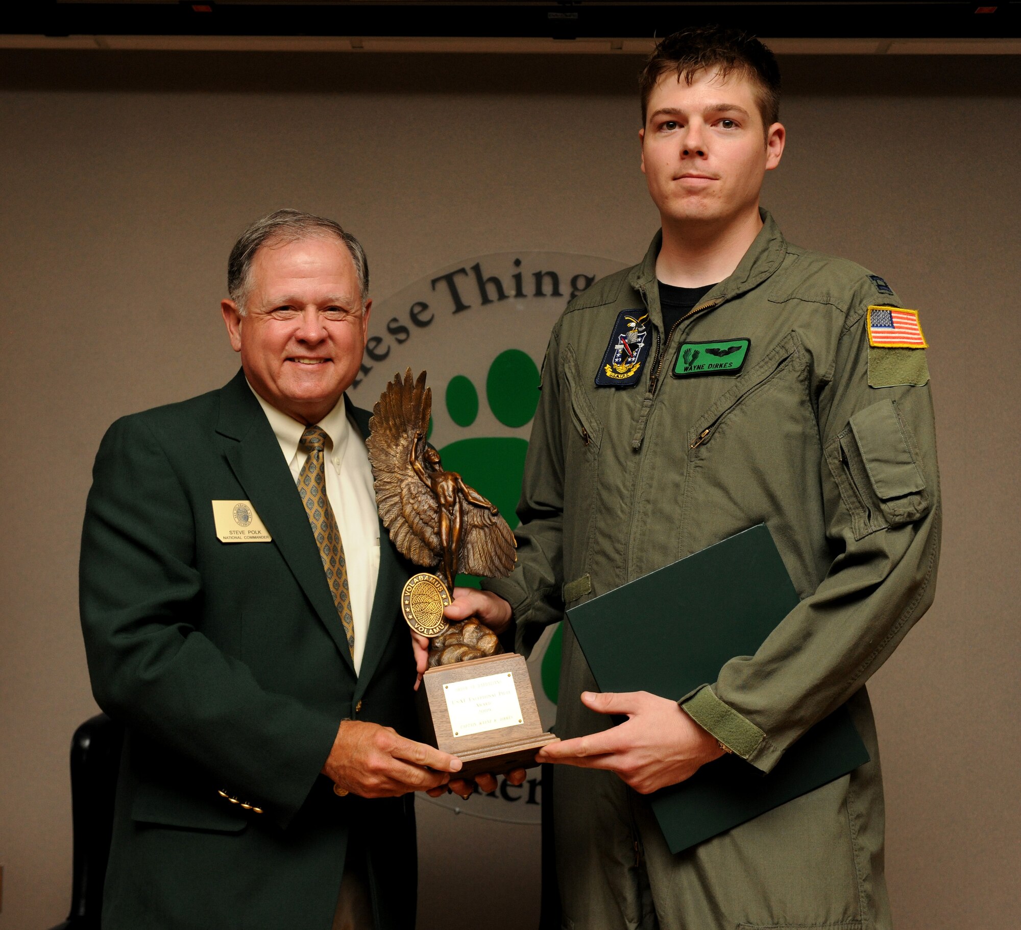MOODY AIR FORCE BASE, Ga. -- Capt. Wayne Dirkes, Naval Test Pilot School student, receives the 2009 Exceptional Pilot Award from retired Lt. Gen. Steve Polk, Order of the Daedalians national commander, here July 16.The award is presented annually to a pilot selected by each of the five military branches. Selection for this award is based on exceptional deeds performed to assure mission success, acts of valor as an aviator, or an extraordinary display of courage or leadership in the air in support of an air operation. The Order of the Daedalians is a national fraternity for military pilots and encourages patriotism, integrity and good character   (U.S. Air Force photo by Airman 1st Class Benjamin Wiseman/RELEASED)